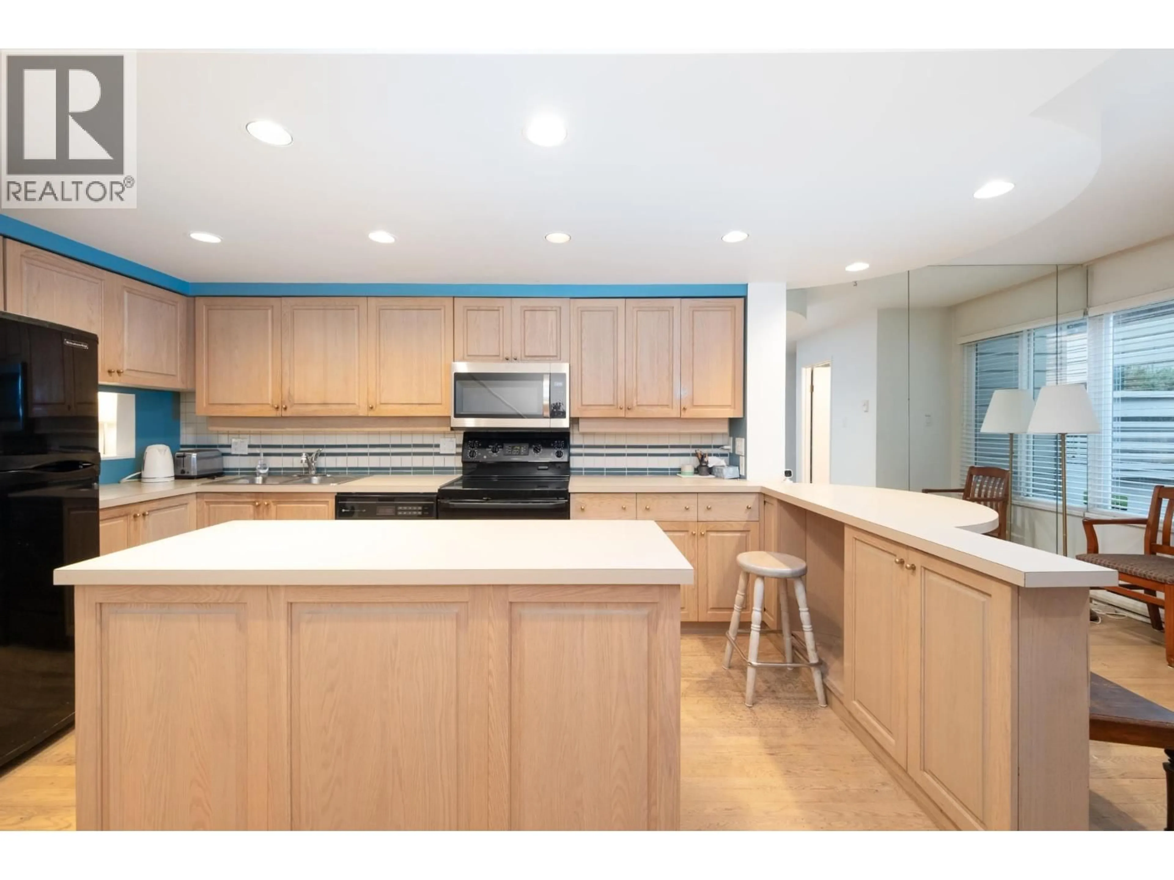 Open concept kitchen, wood/laminate floor for 4083 PARKWAY DRIVE, Vancouver British Columbia V6L3C9
