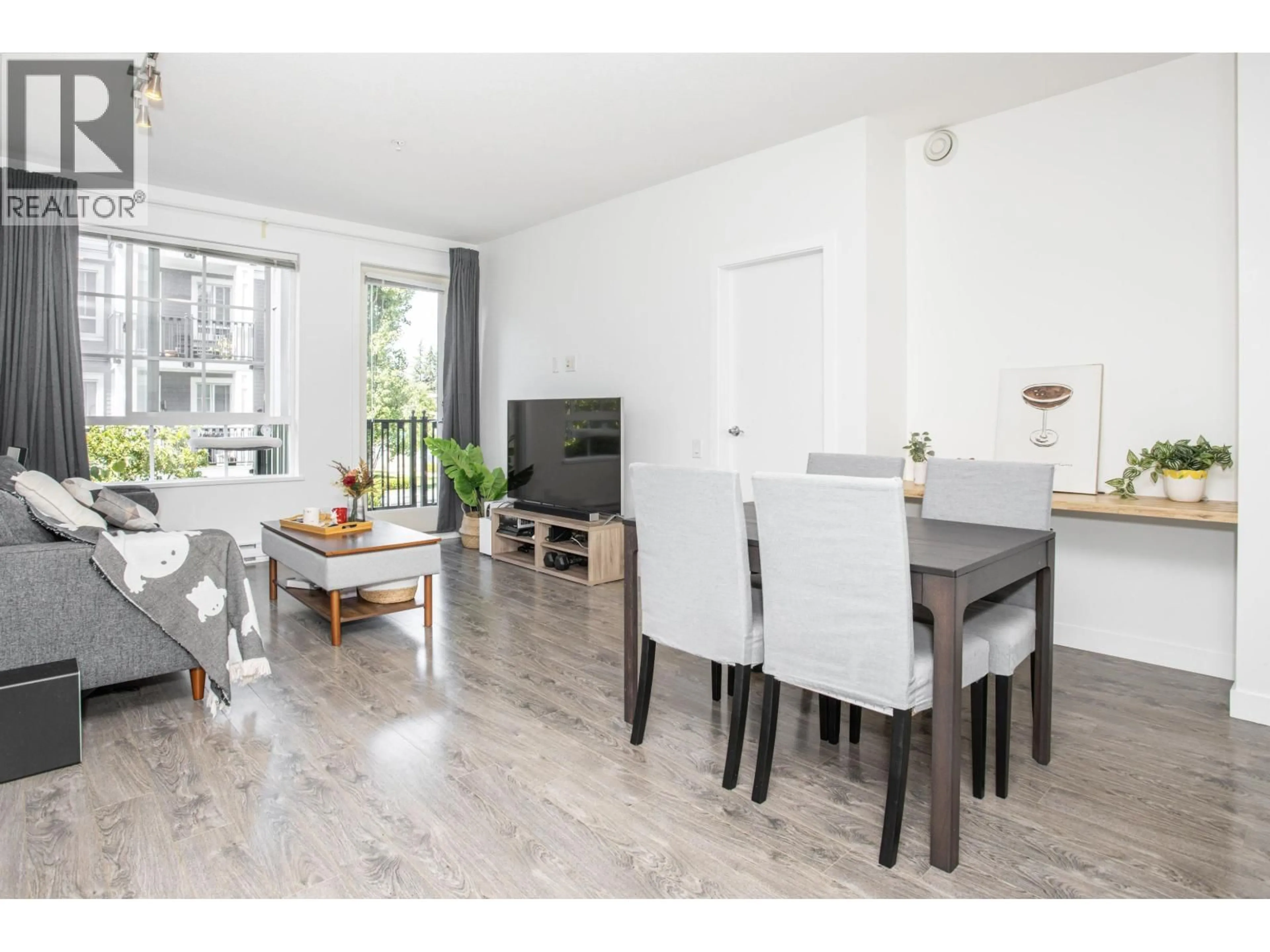 Living room with furniture, wood/laminate floor for 207 - 553 FOSTER AVENUE, Coquitlam British Columbia V3J0B5