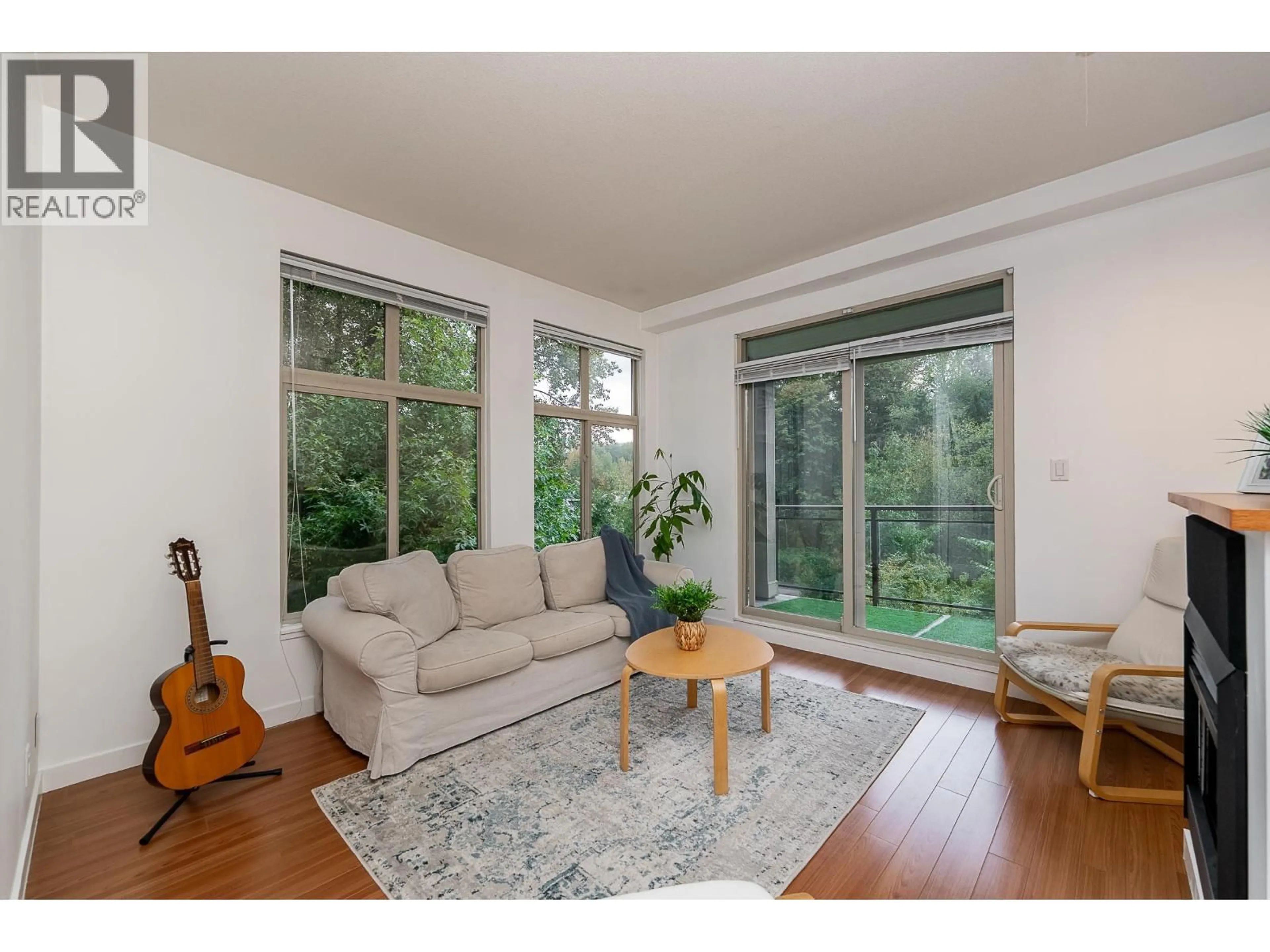 Living room with furniture, wood/laminate floor for 310 - 101 MORRISSEY ROAD, Port Moody British Columbia V3H0E6
