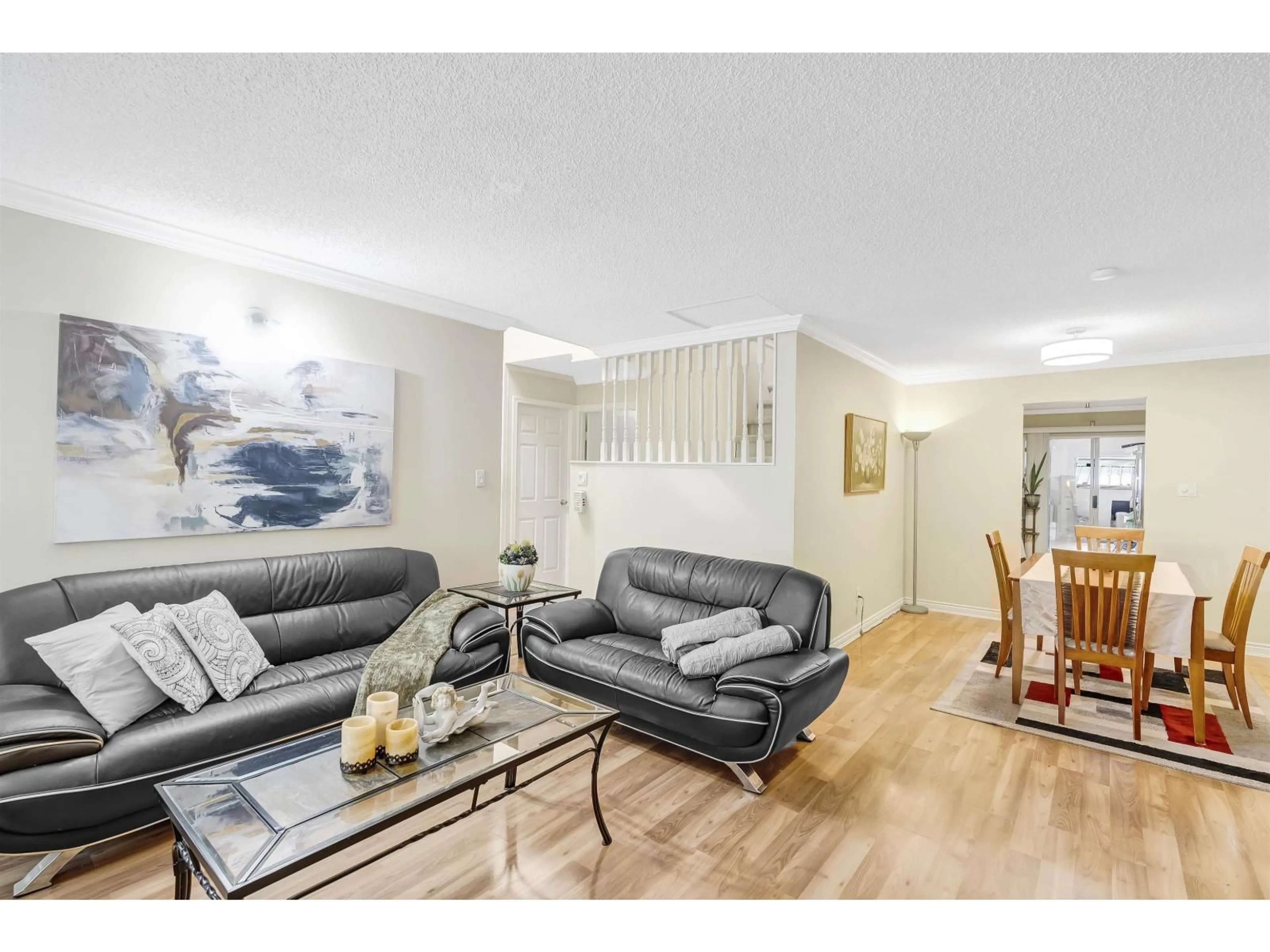 Living room with furniture, wood/laminate floor for 14783 101, Surrey British Columbia V3R7H7