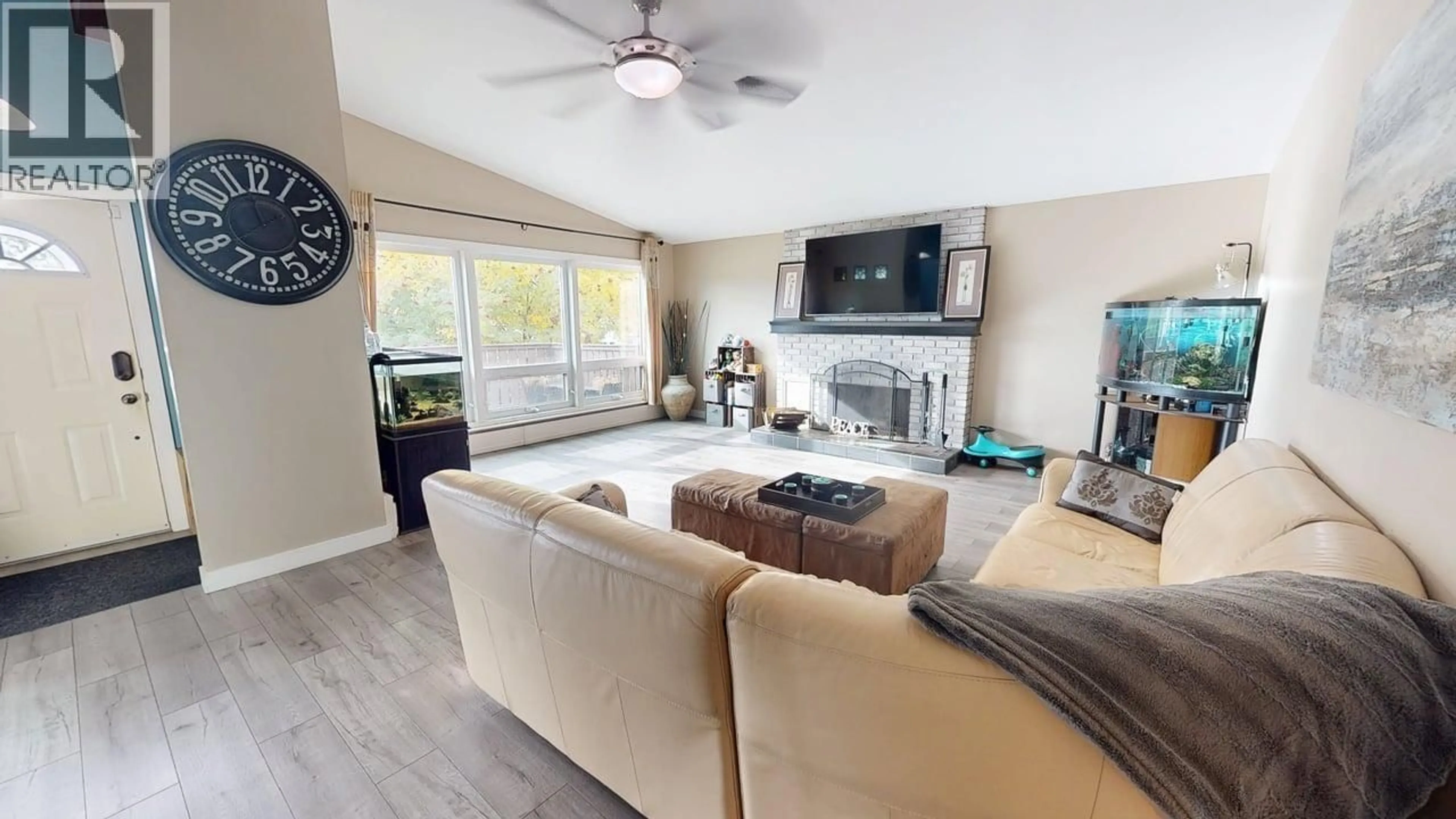 Living room with furniture, wood/laminate floor for 9308 112 AVENUE, Fort St. John British Columbia V1J2V9