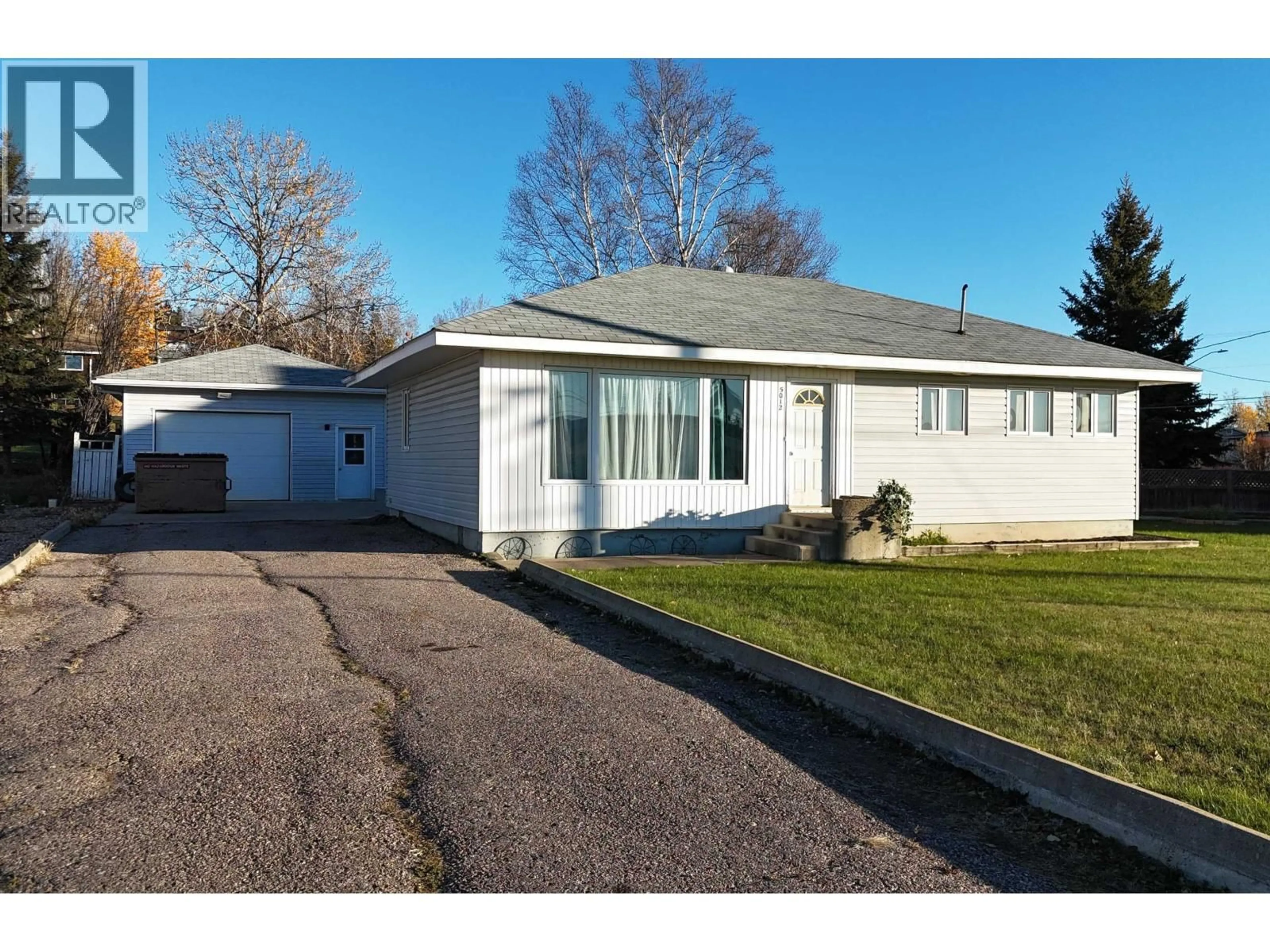 Home with vinyl exterior material, street for 5012 52 AVENUE, Fort Nelson British Columbia V0C1R0