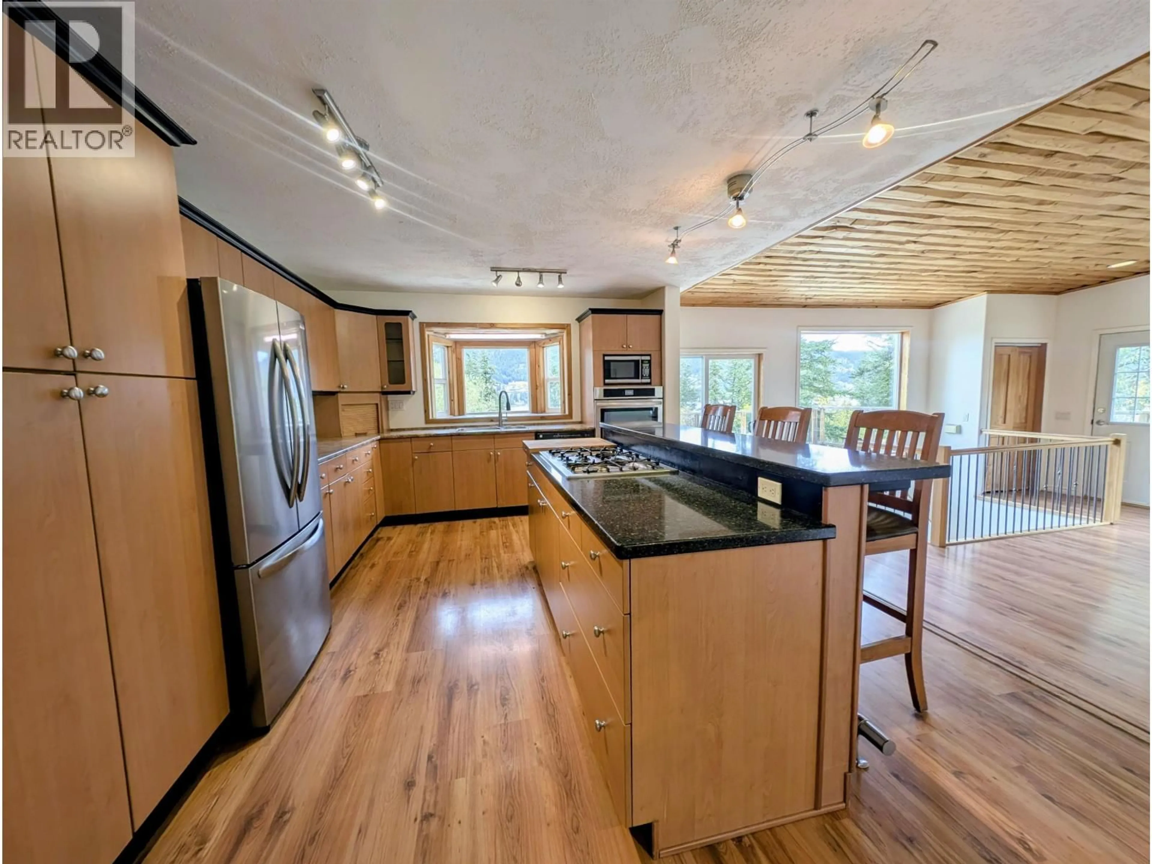 Open concept kitchen, wood/laminate floor for 1606 JUNIPER STREET, Williams Lake British Columbia V2G3C3