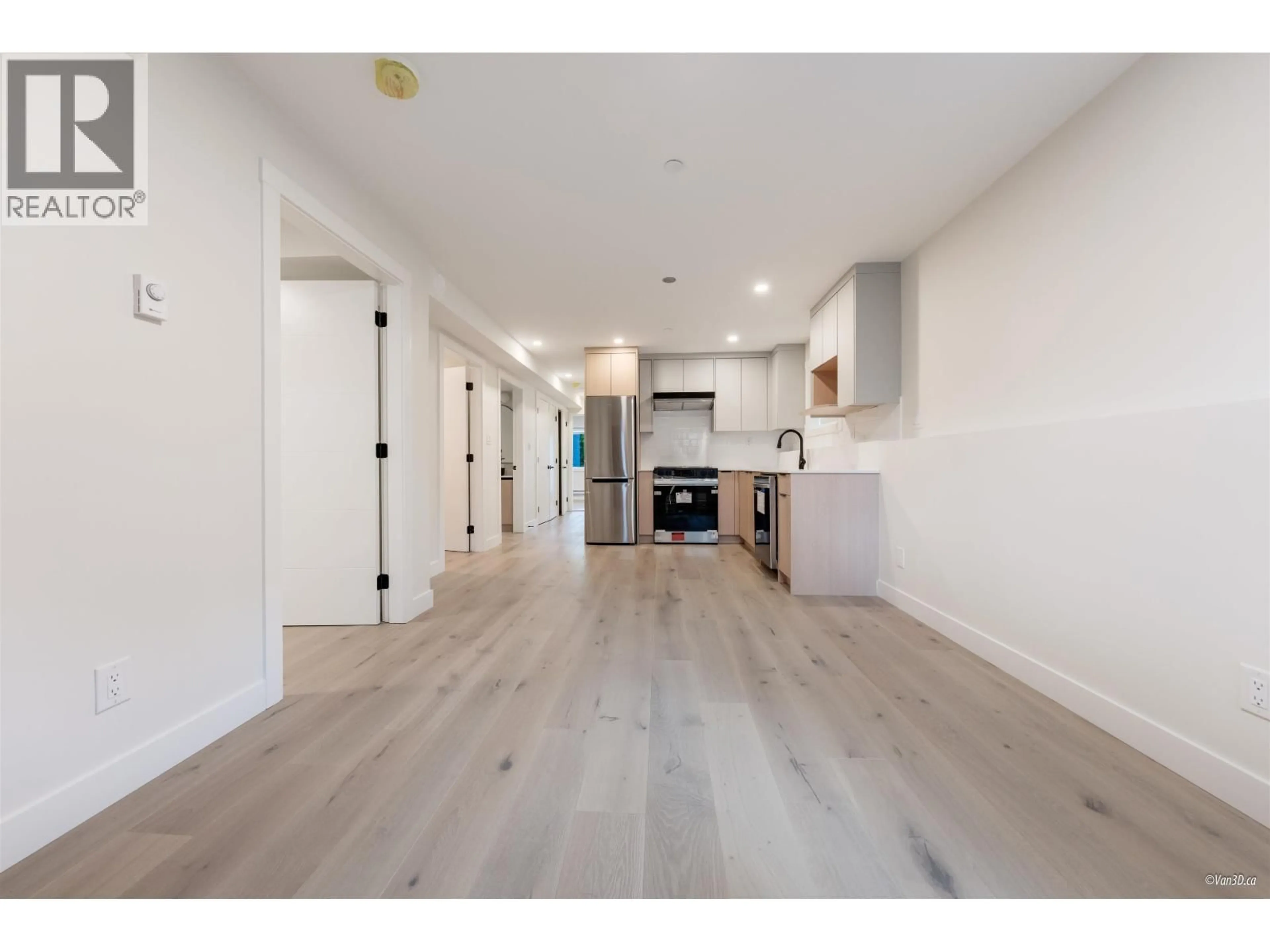 Open concept kitchen, wood/laminate floor for 101 - 5092 SLOCAN STREET, Vancouver British Columbia V5R2A5