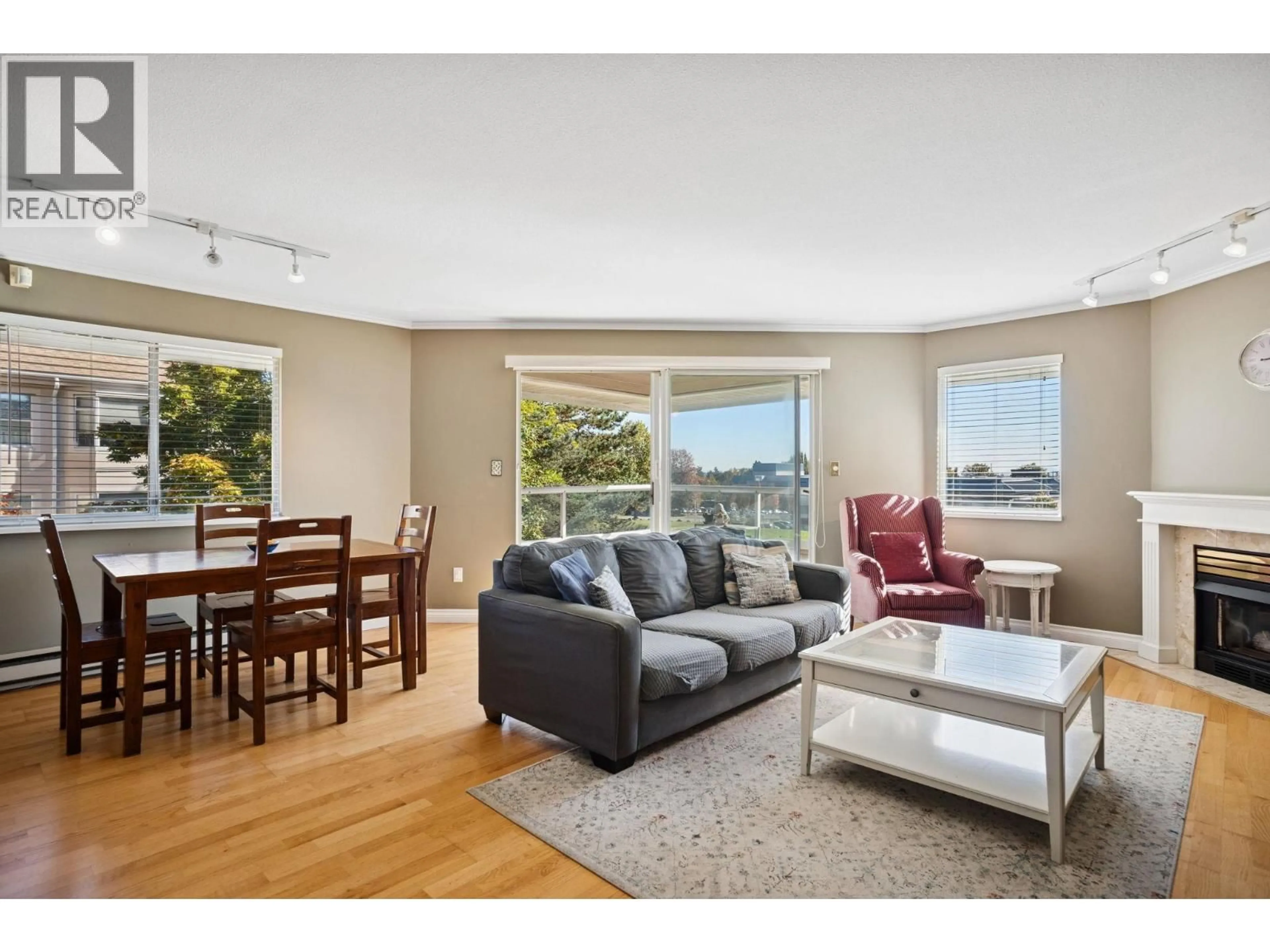 Living room with furniture, wood/laminate floor for 304 - 5350 VICTORY STREET, Burnaby British Columbia V5J1T1