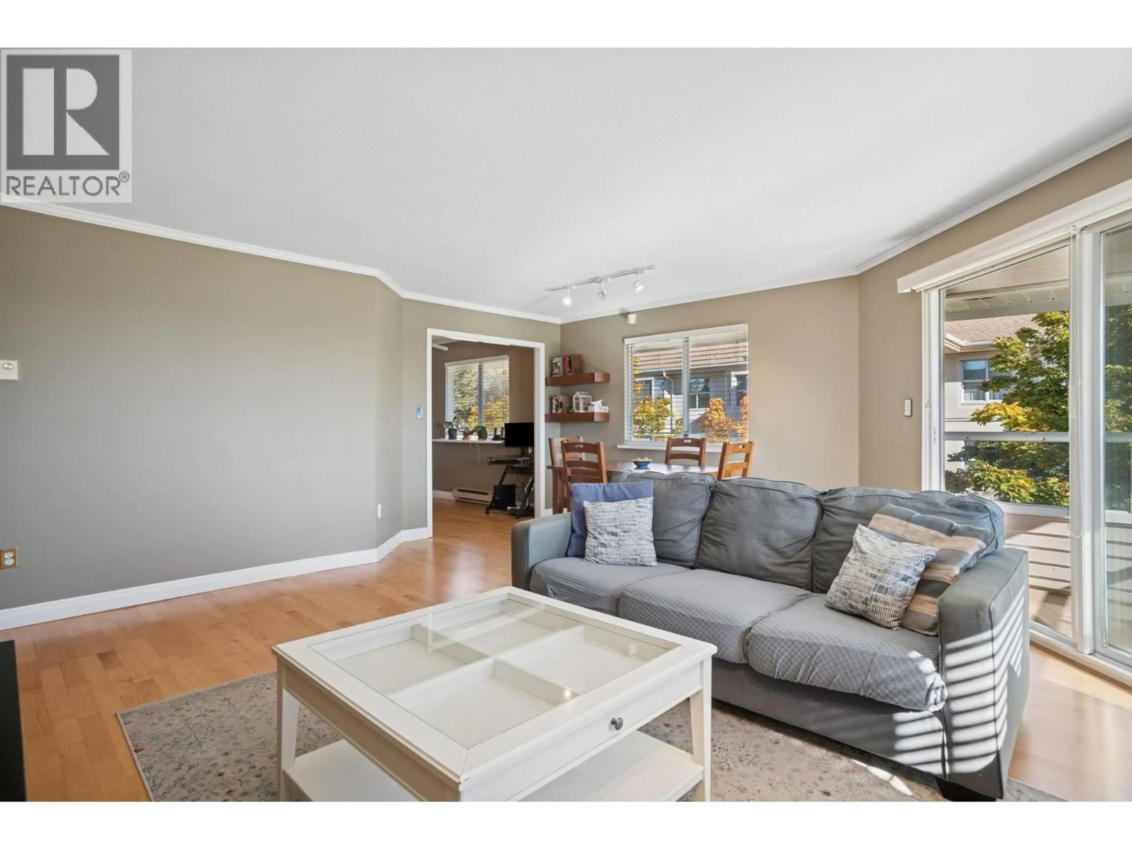 Living room with furniture, wood/laminate floor for 304 - 5350 VICTORY STREET, Burnaby British Columbia V5J1T1