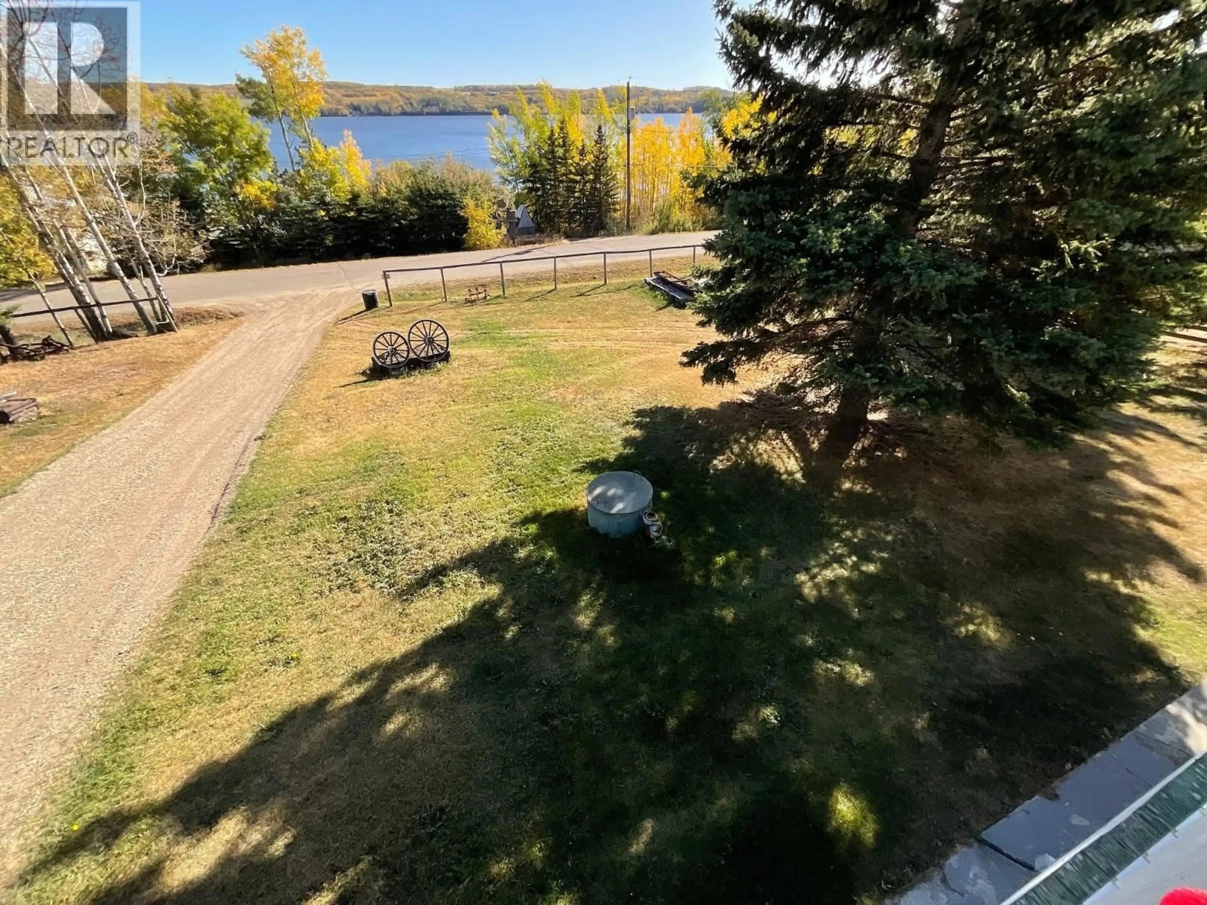 A pic from outside/outdoor area/front of a property/back of a property/a pic from drone, water/lake/river/ocean view for 13235 LAKE SHORE DRIVE, Charlie Lake British Columbia V1J8G1
