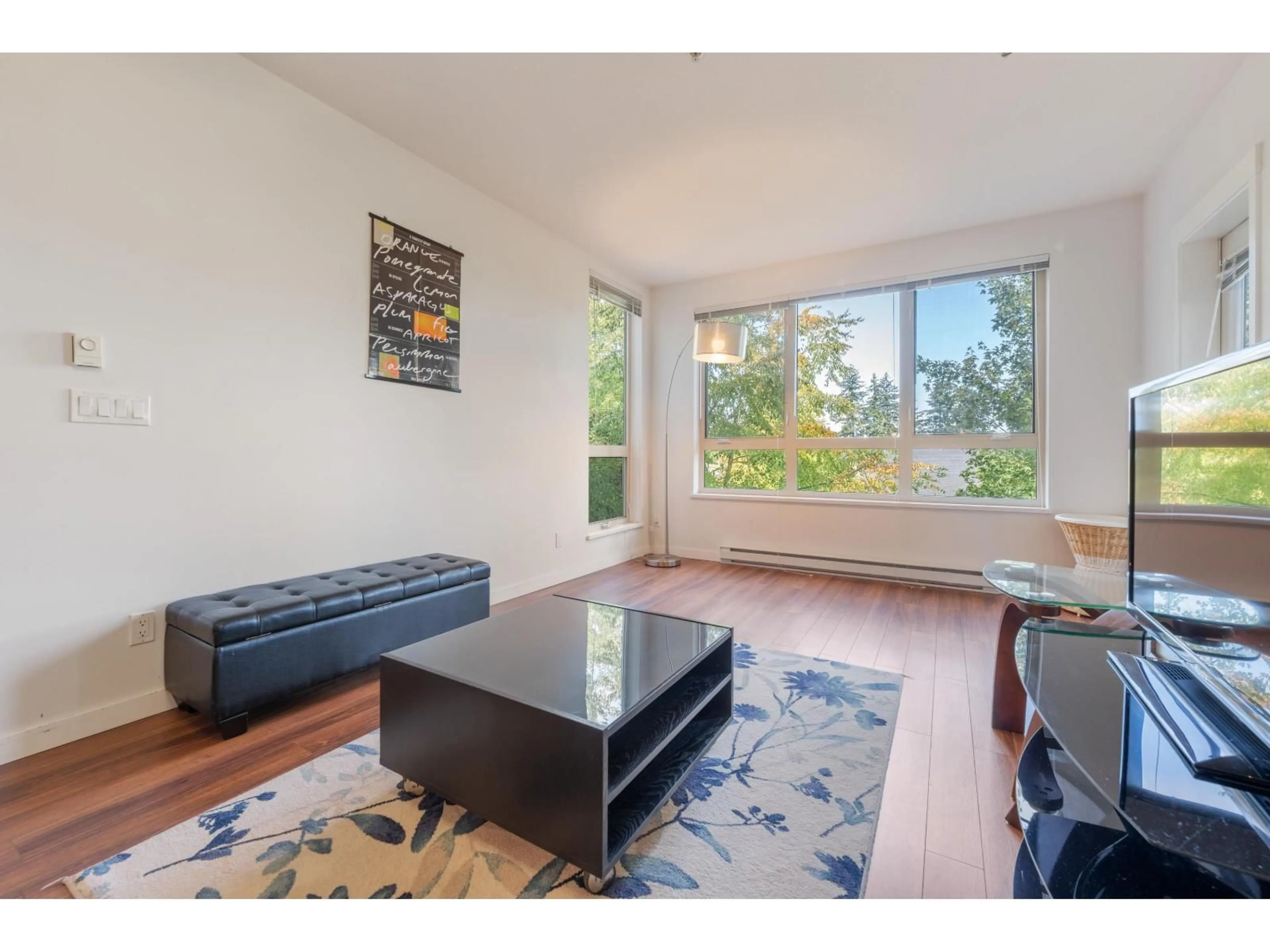 Living room with furniture, wood/laminate floor for 311 - 15918 26, Surrey British Columbia V3Z5K3