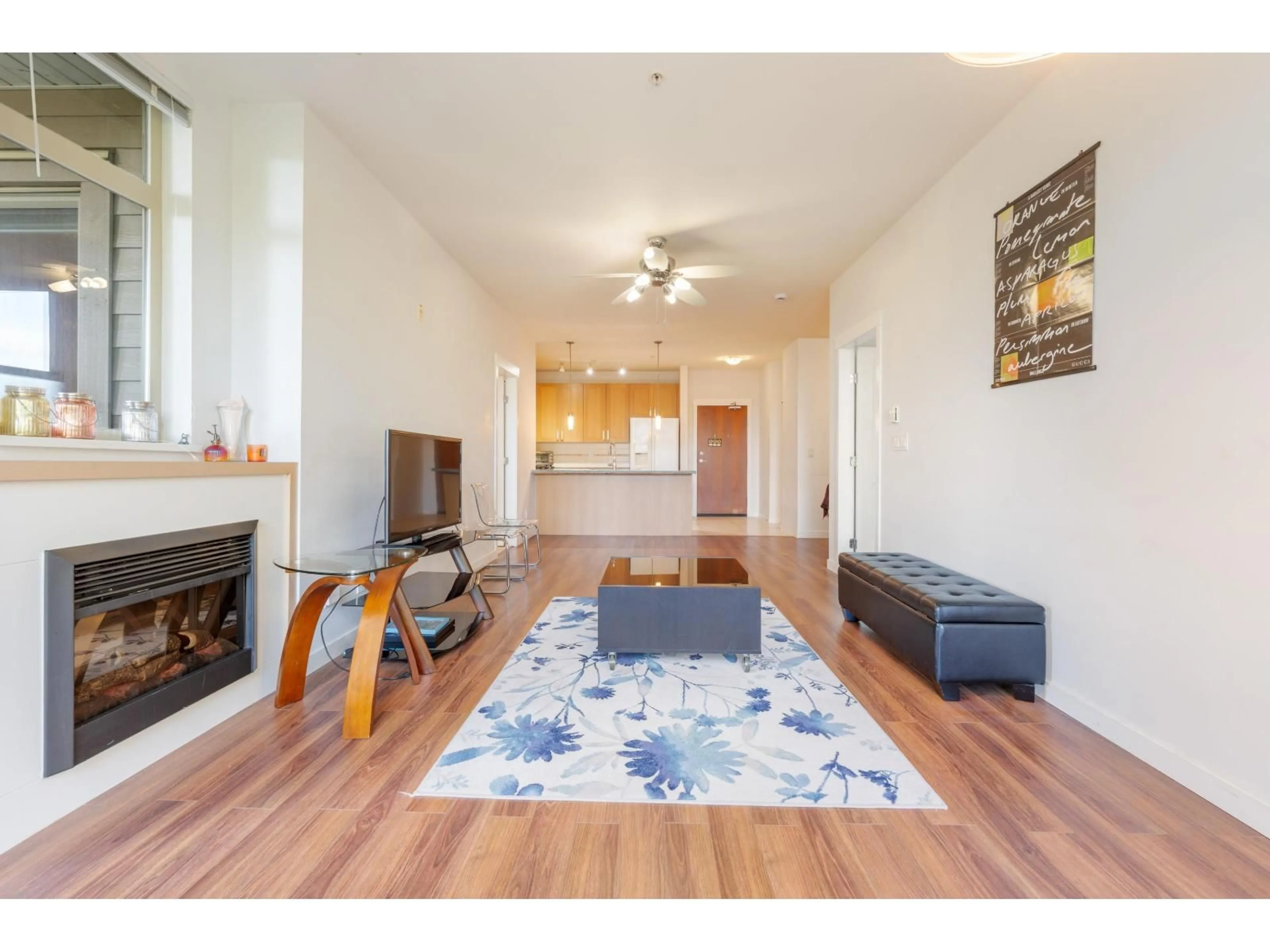 Living room with furniture, wood/laminate floor for 311 - 15918 26, Surrey British Columbia V3Z5K3