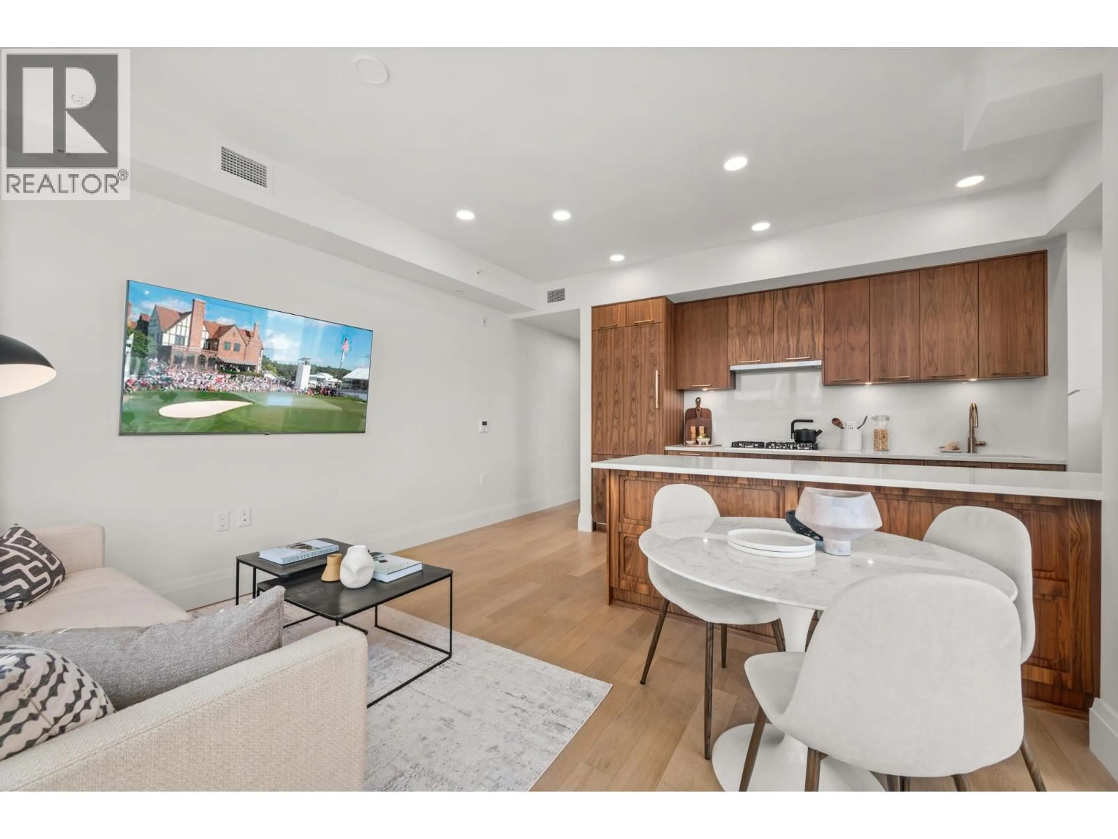 Open concept kitchen, wood/laminate floor for 313 - 2550 GARDEN DRIVE, Vancouver British Columbia V5N4X6