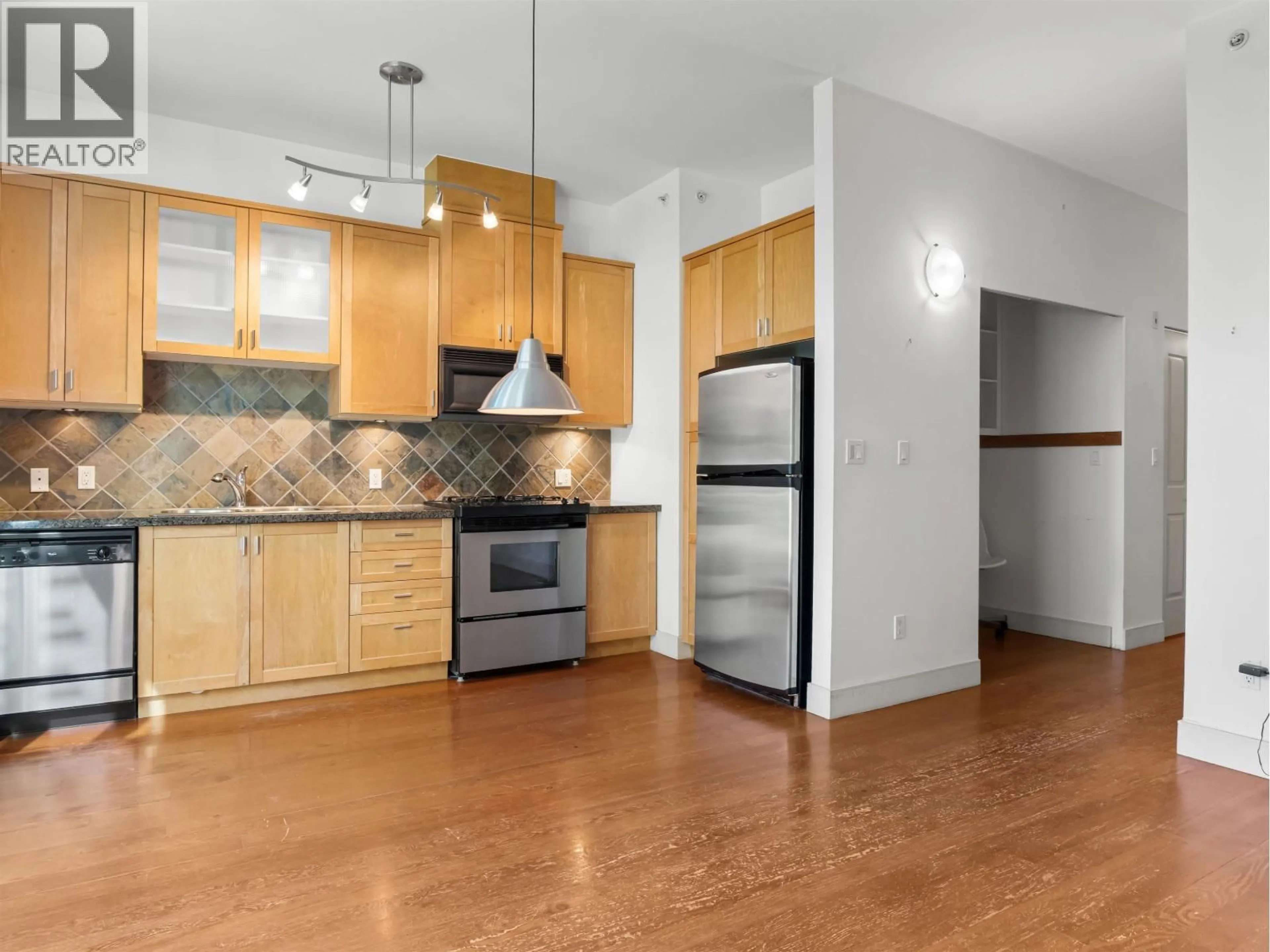 Open concept kitchen, wood/laminate floor for 110 - 8988 HUDSON STREET, Vancouver British Columbia V6P6Z1