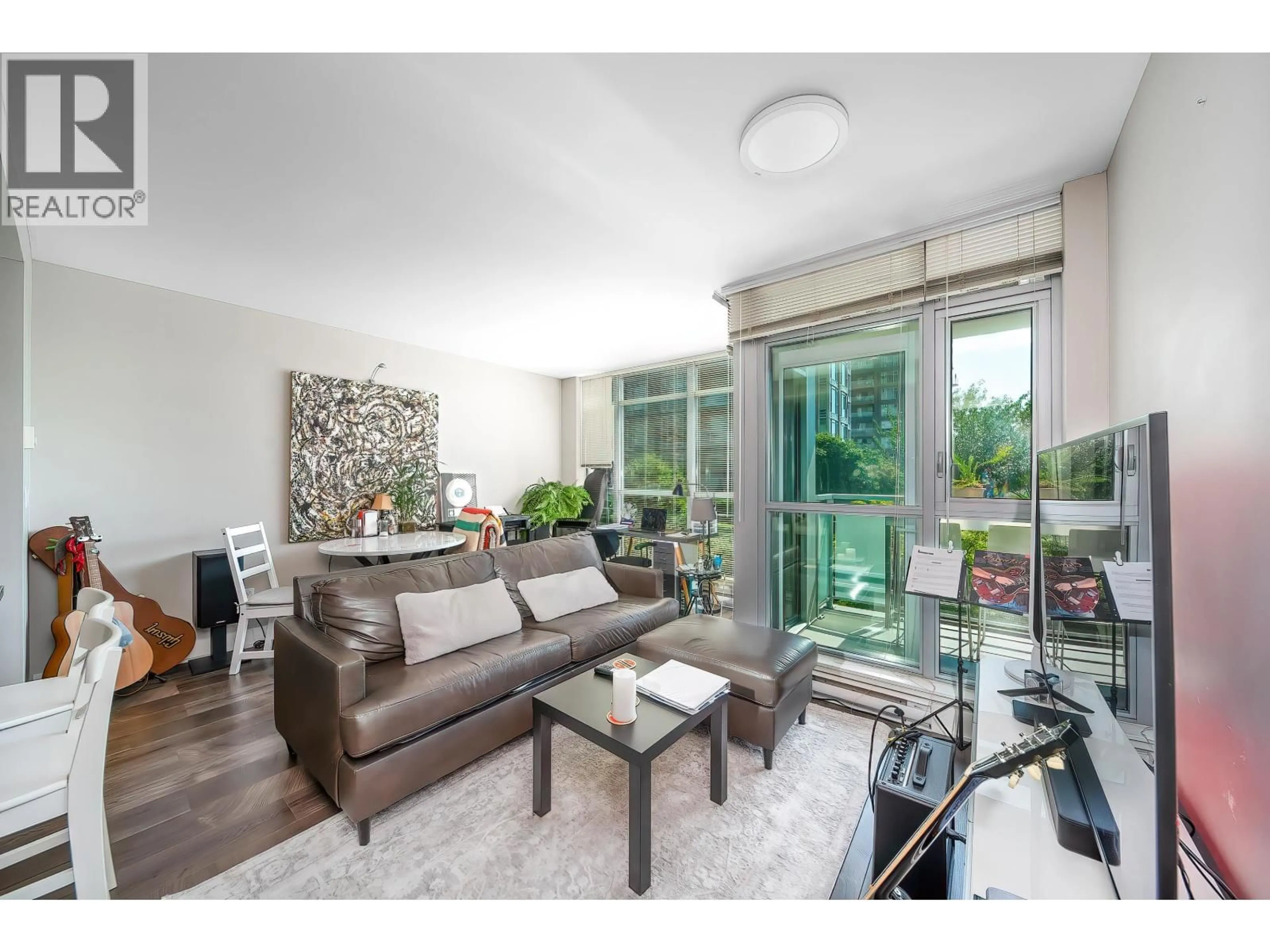 Living room with furniture, wood/laminate floor for 608 - 3008 GLEN DRIVE, Coquitlam British Columbia V3B0J5
