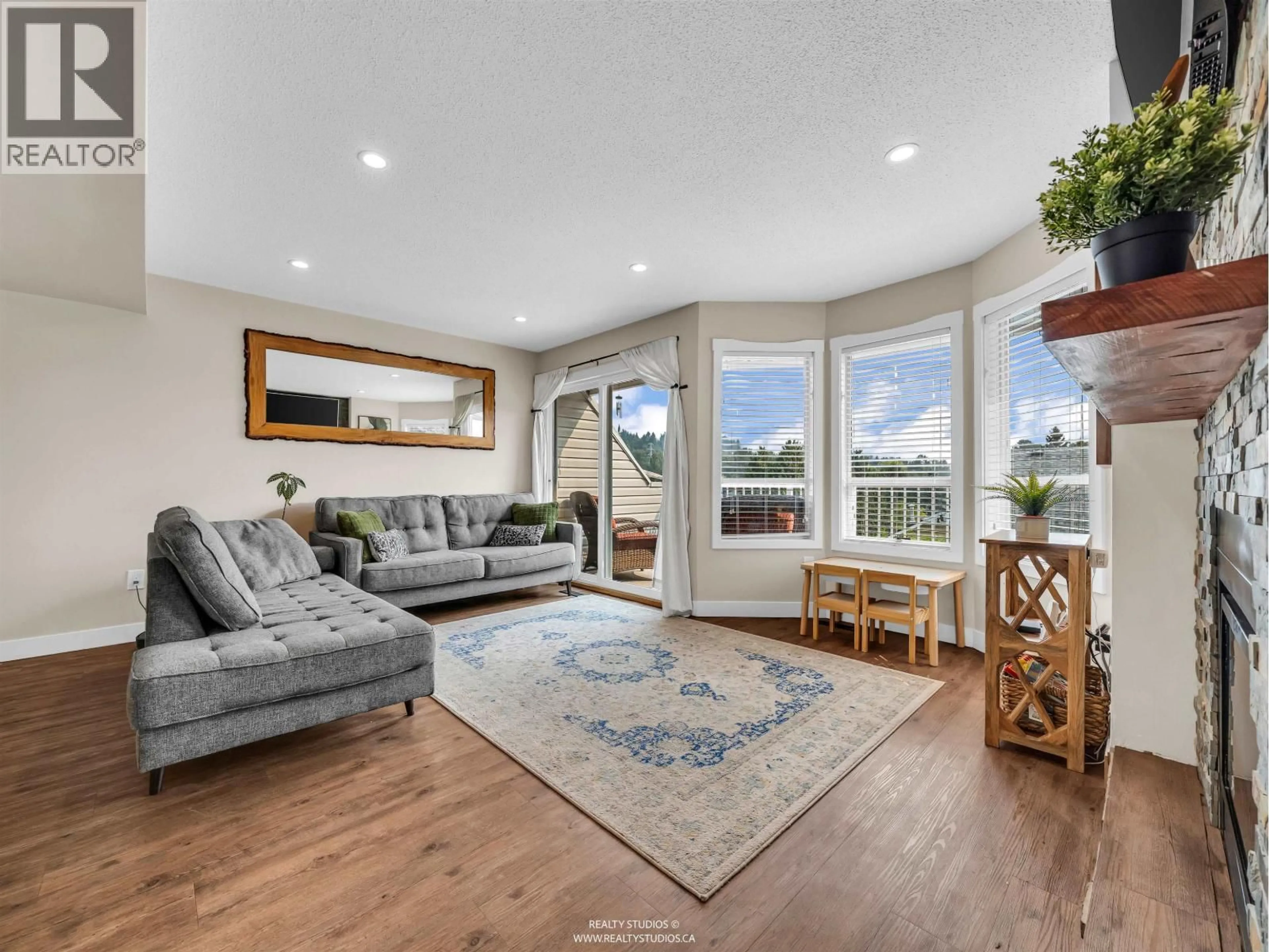 Living room with furniture, wood/laminate floor for 405 - 1176 FALCON DRIVE, Coquitlam British Columbia V3E2N7