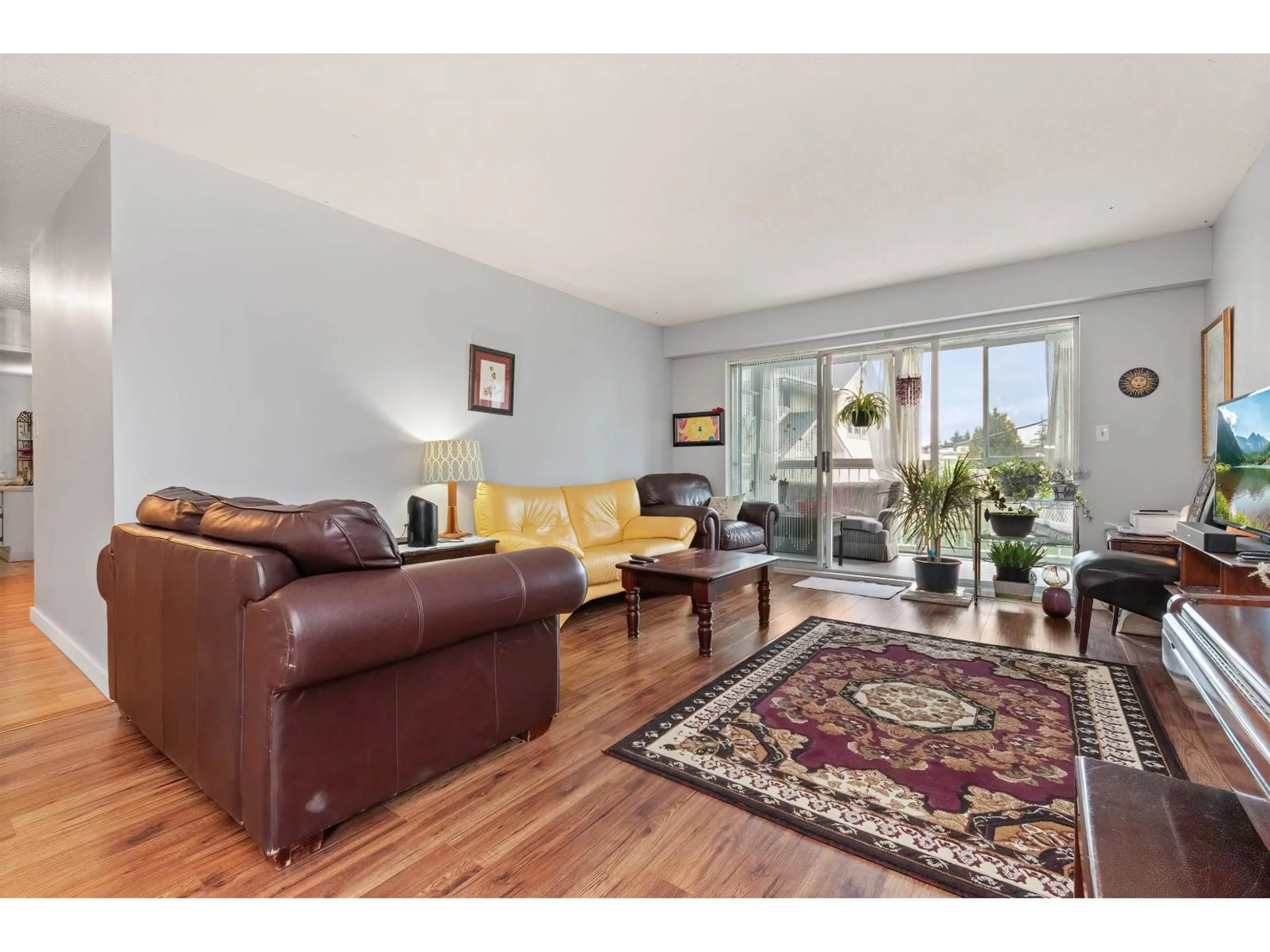 Living room with furniture, wood/laminate floor for 211 - 32025 TIMS, Abbotsford British Columbia V2T2H3