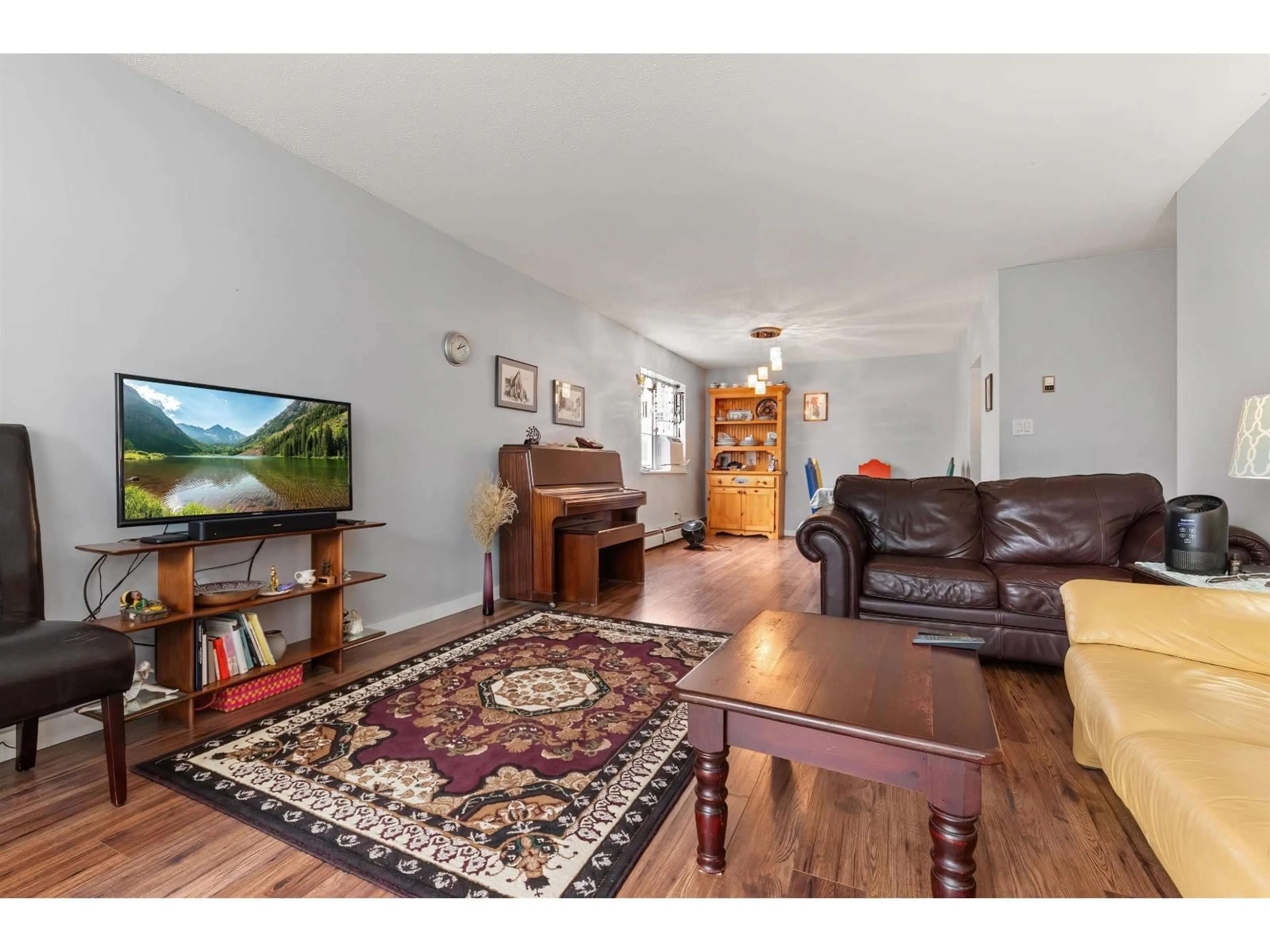 Living room with furniture, wood/laminate floor for 211 - 32025 TIMS, Abbotsford British Columbia V2T2H3