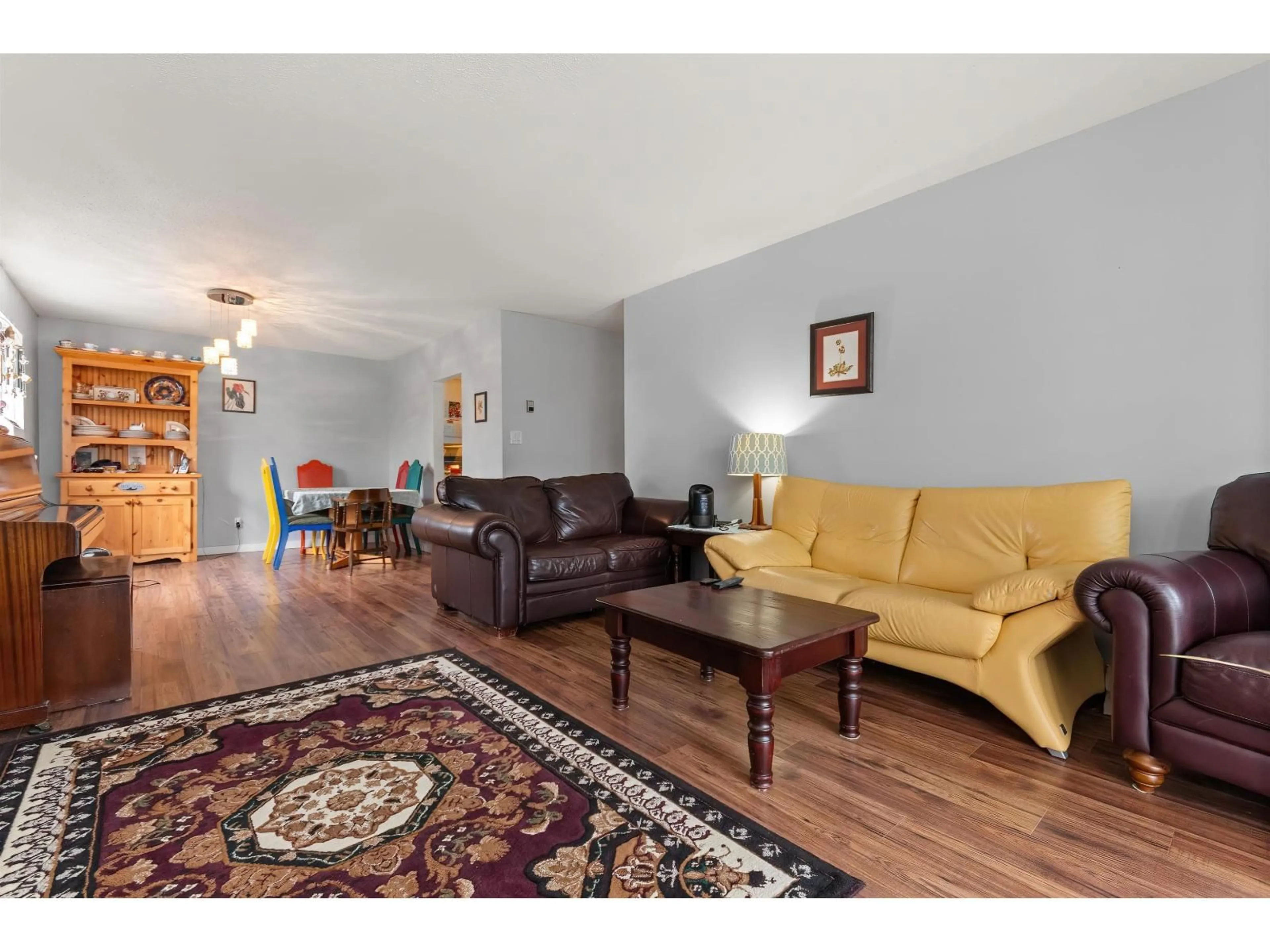 Living room with furniture, wood/laminate floor for 211 - 32025 TIMS, Abbotsford British Columbia V2T2H3