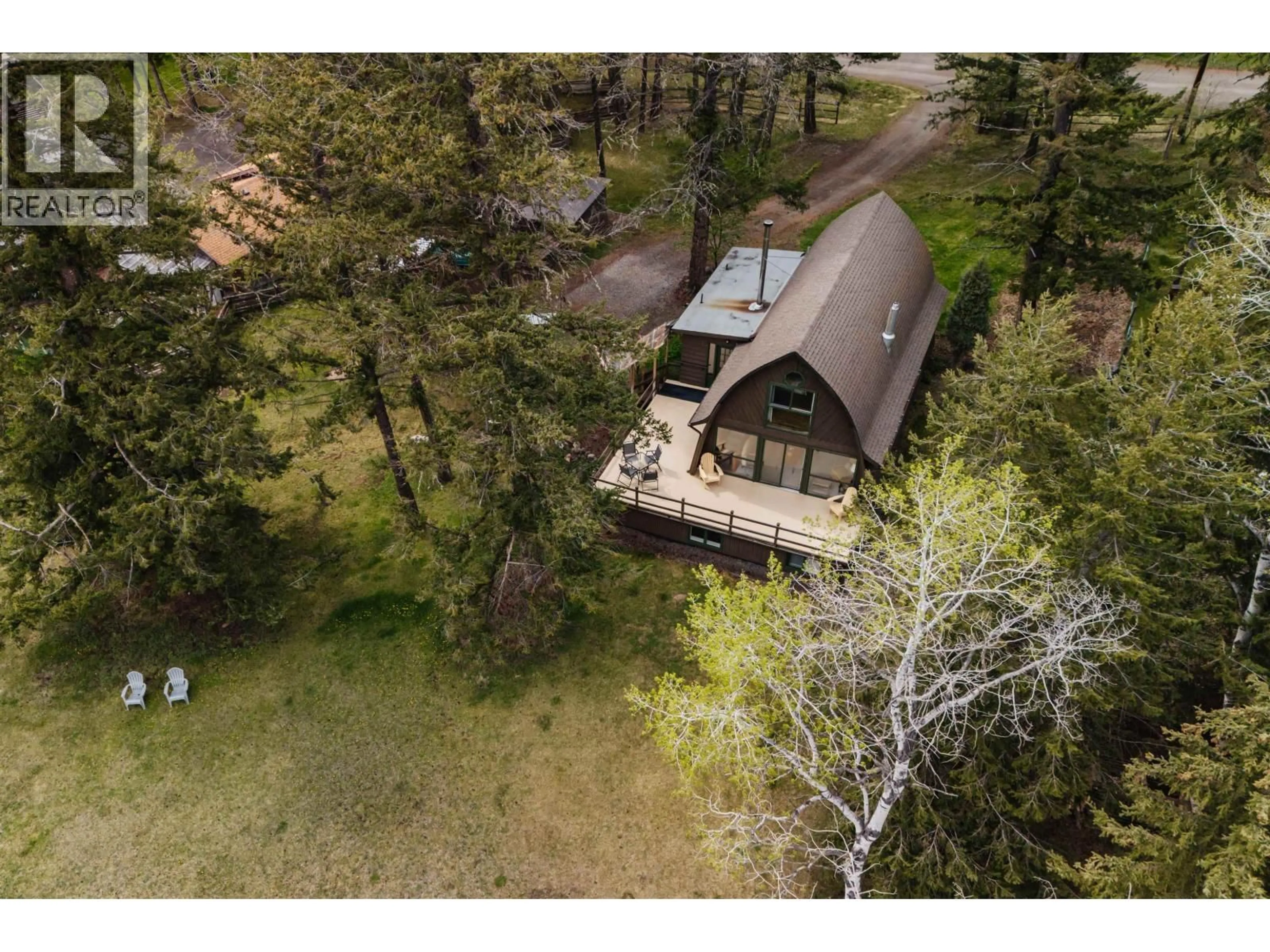 A pic from outside/outdoor area/front of a property/back of a property/a pic from drone, forest/trees view for 5359 ANNAHAM CRESCENT, 108 Mile Ranch British Columbia V0K2Z0