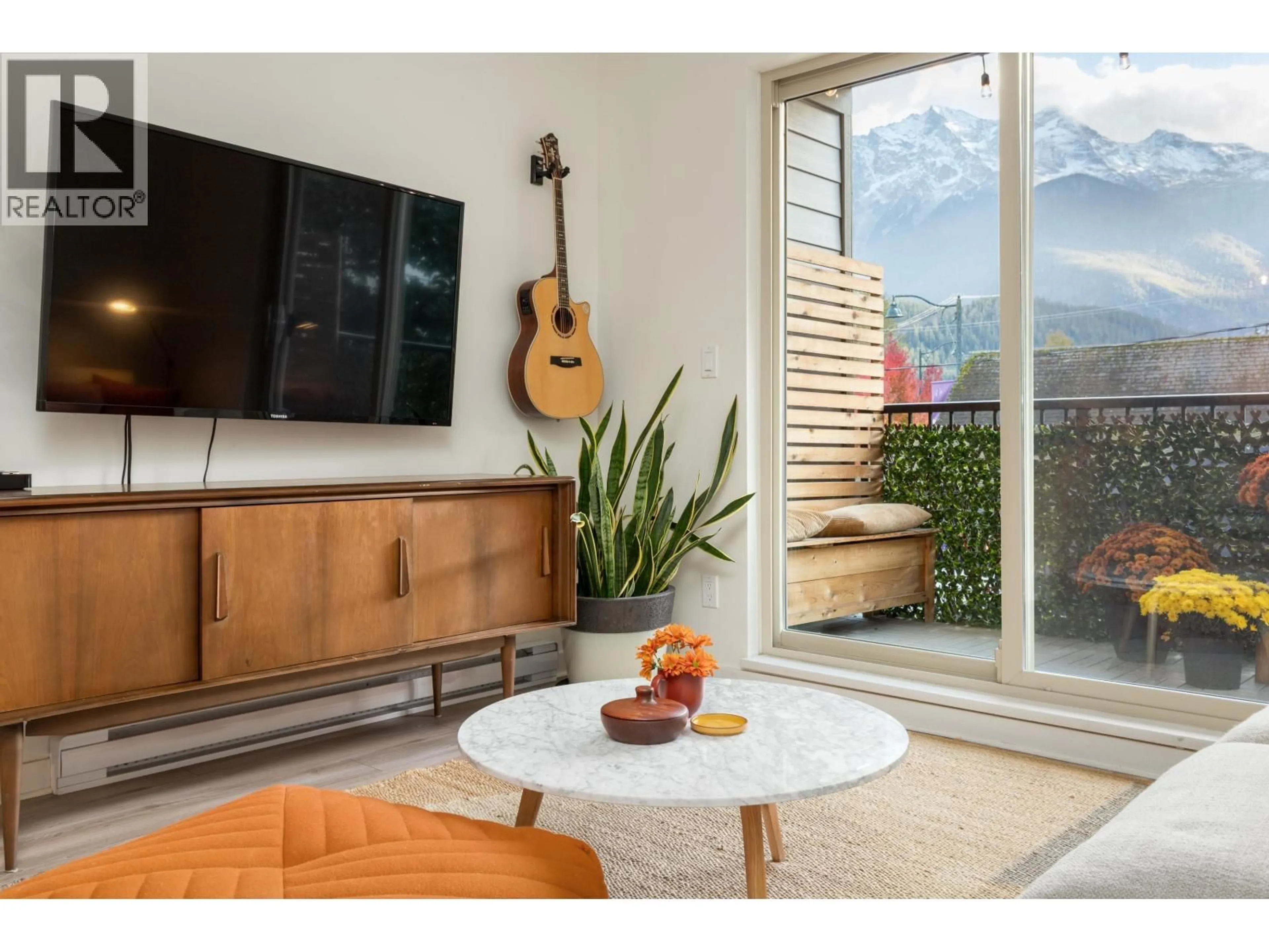 Living room with furniture, wood/laminate floor for 213 - 7445 FRONTIER STREET, Pemberton British Columbia V0N2L1