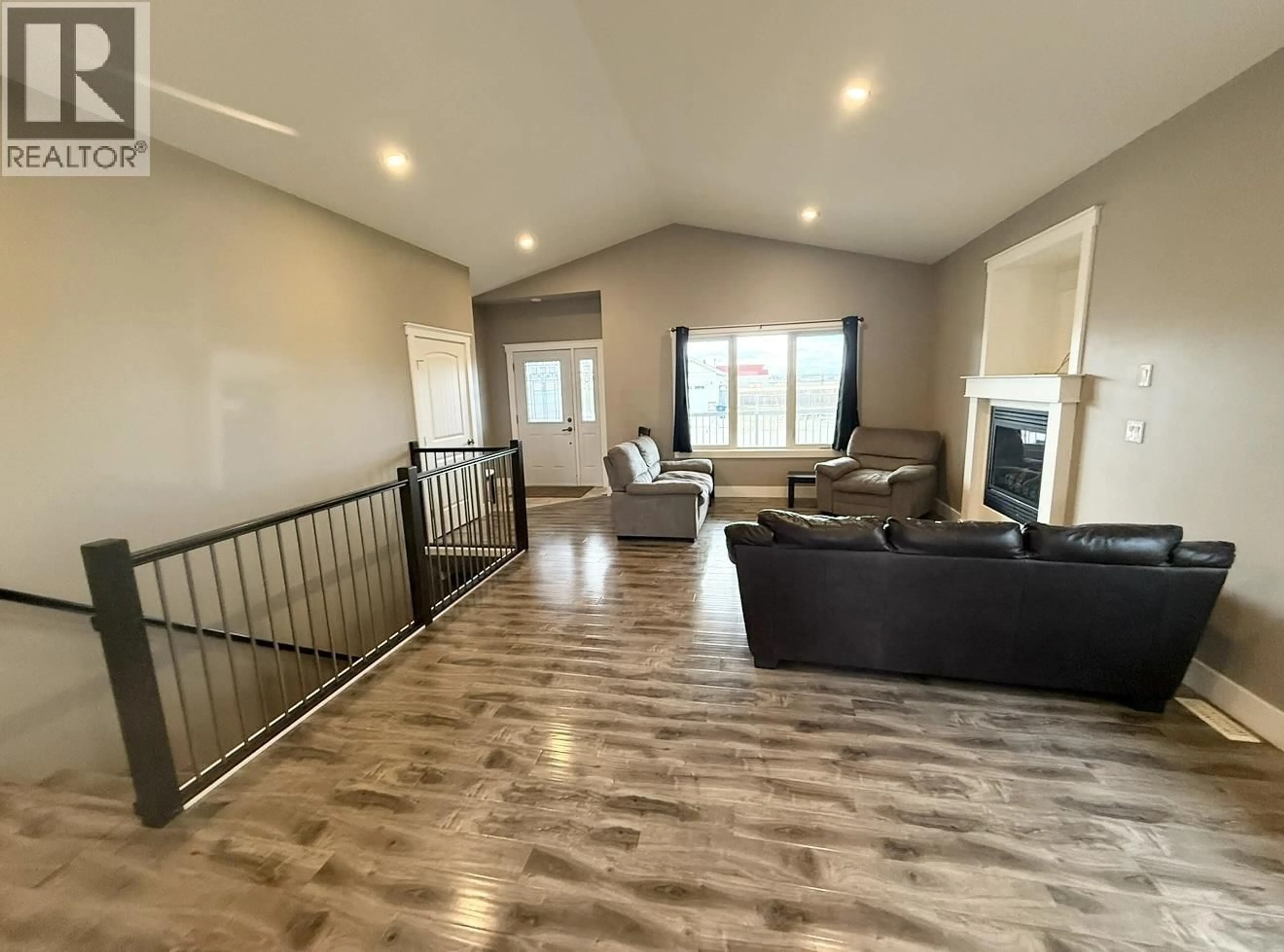 Living room with furniture, wood/laminate floor for 10511 111 STREET, Fort St. John British Columbia V1J0L6