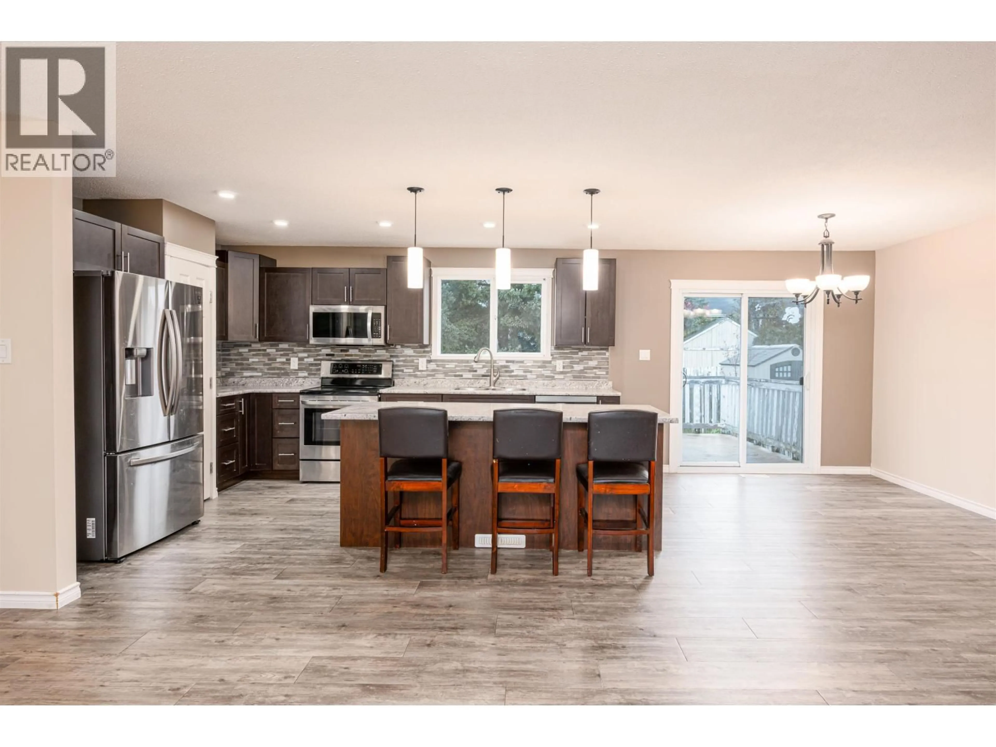 Open concept kitchen, wood/laminate floor for 1178 FRANCOIS CRESCENT, Prince George British Columbia V2M4H3