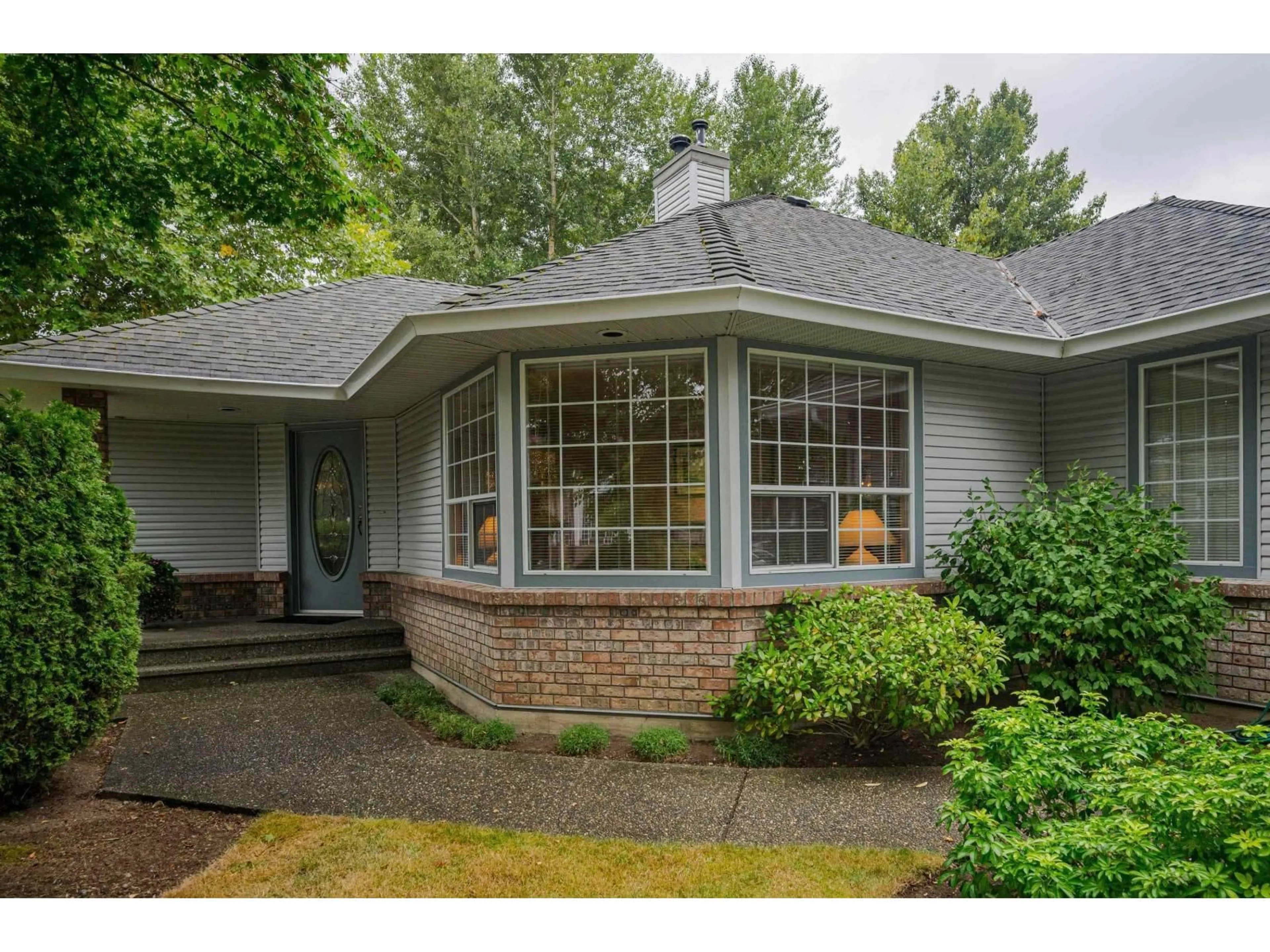 Home with vinyl exterior material, street for 8459 142A, Surrey British Columbia V2W0Z8