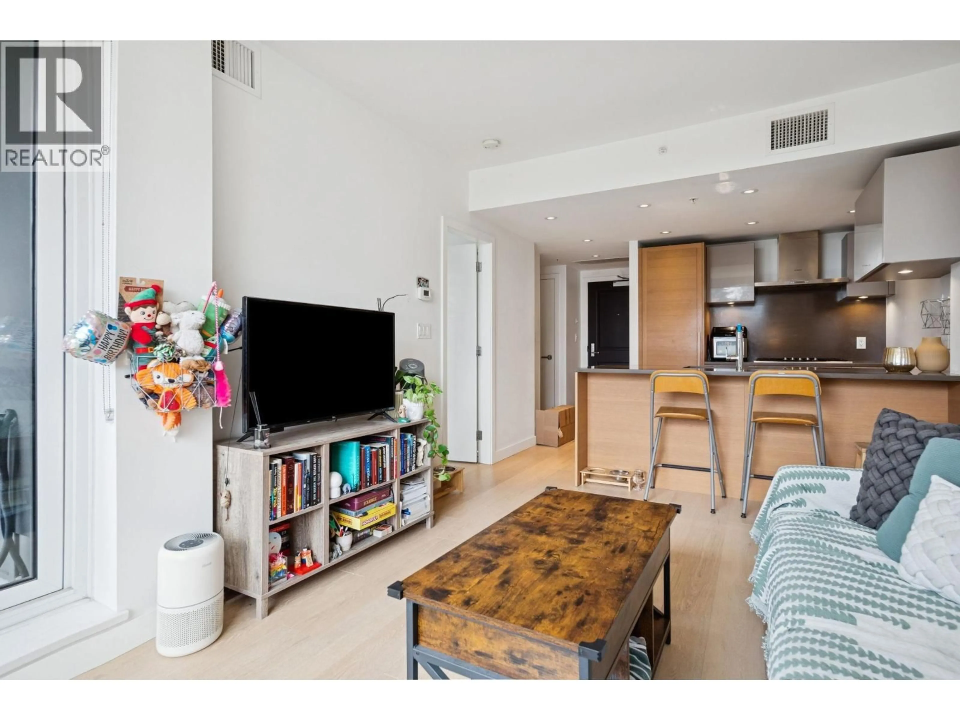 Living room with furniture, wood/laminate floor for 506 - 1515 ATLAS LANE, Vancouver British Columbia V6P0C9