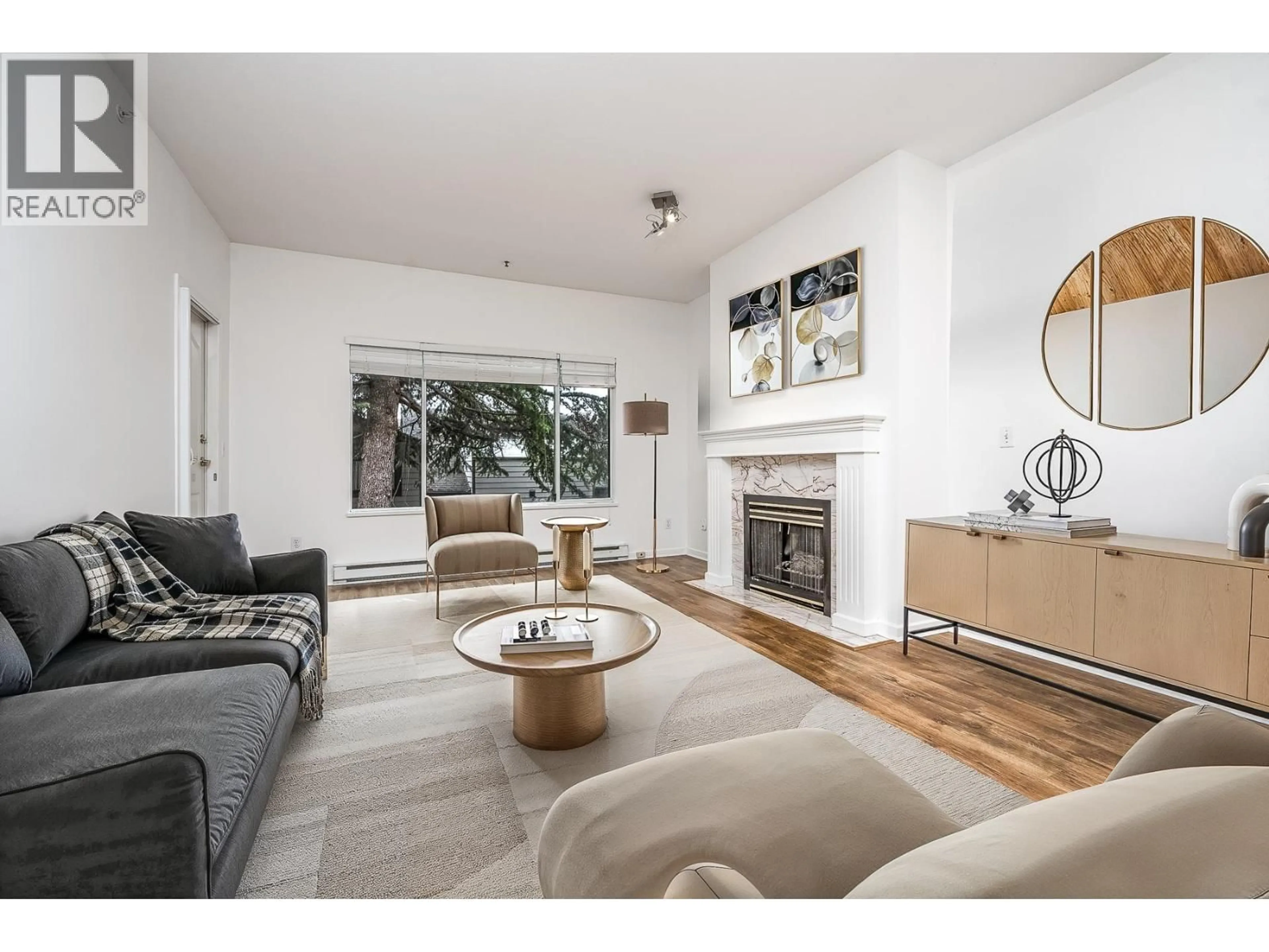 Living room with furniture, wood/laminate floor for 204 - 1153 54A STREET, Delta British Columbia V4M4E4