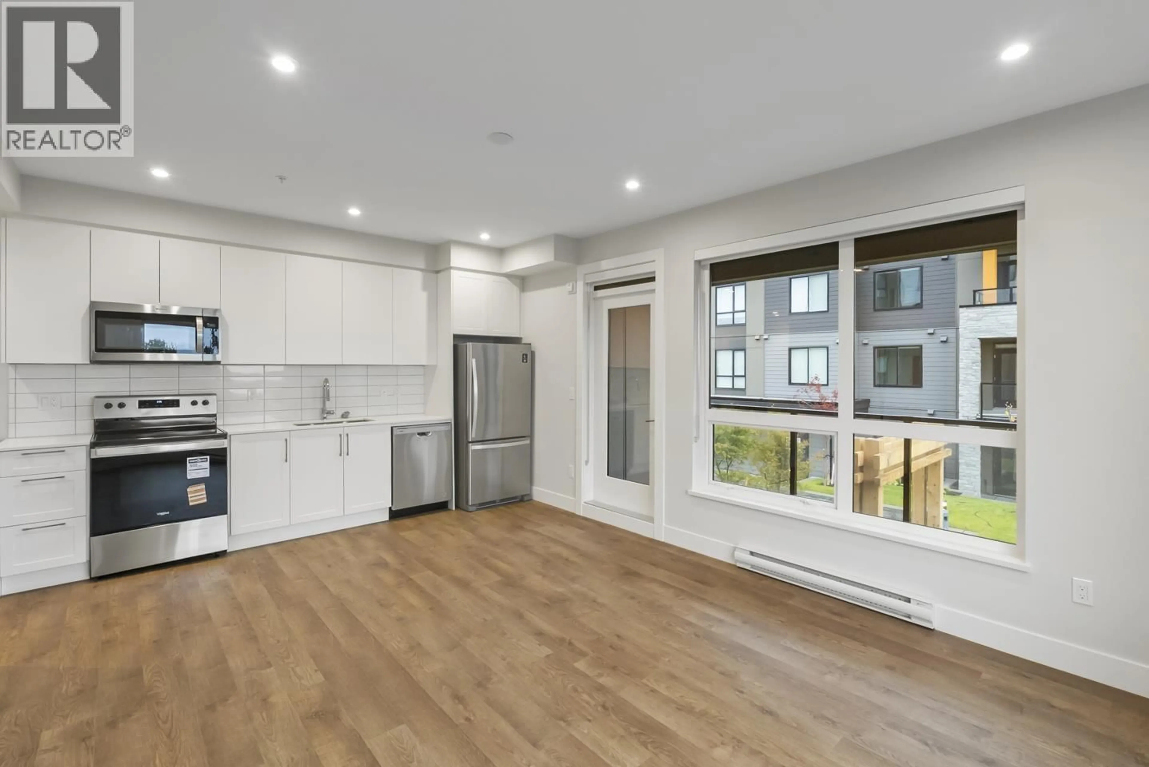 Open concept kitchen, wood/laminate floor for 202 - 1930 STARLING DRIVE, Tsawwassen British Columbia V0V0V0