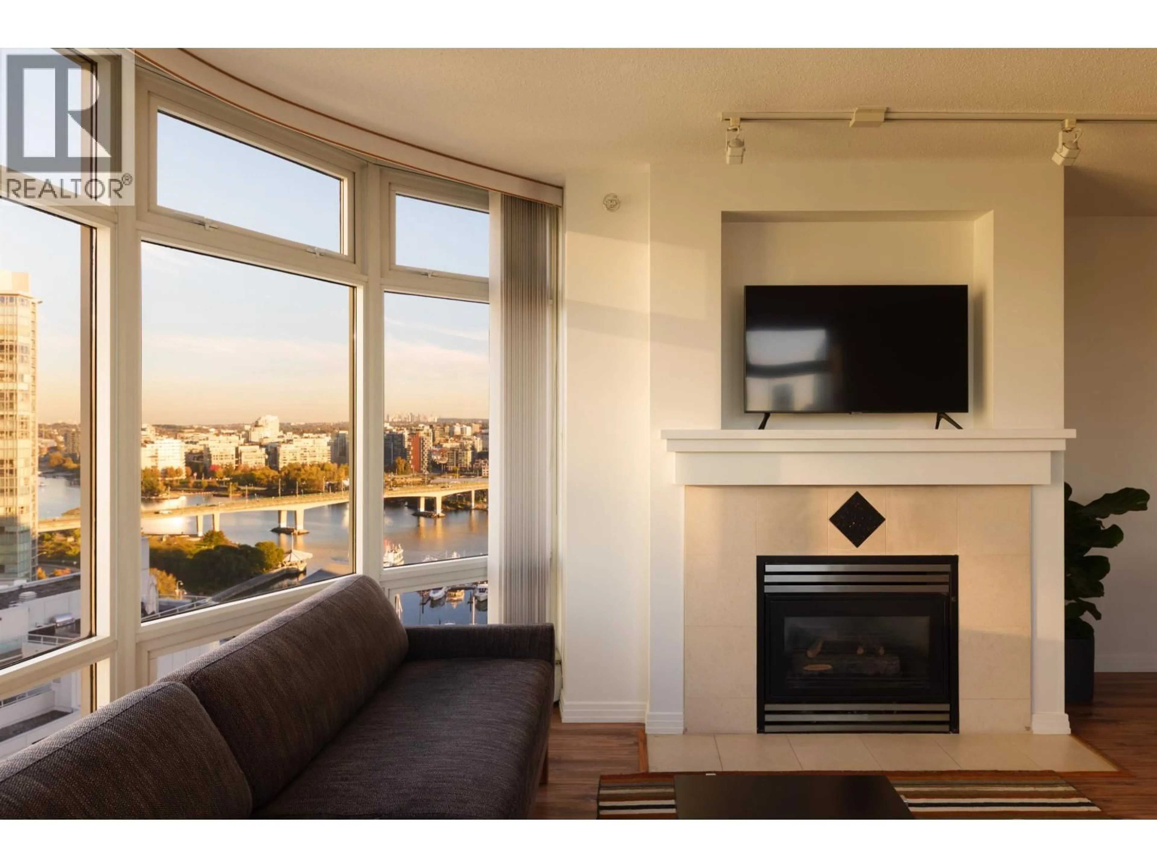 Living room with furniture, wood/laminate floor for 2305 - 1199 MARINASIDE CRESCENT, Vancouver British Columbia V6Z2Y2