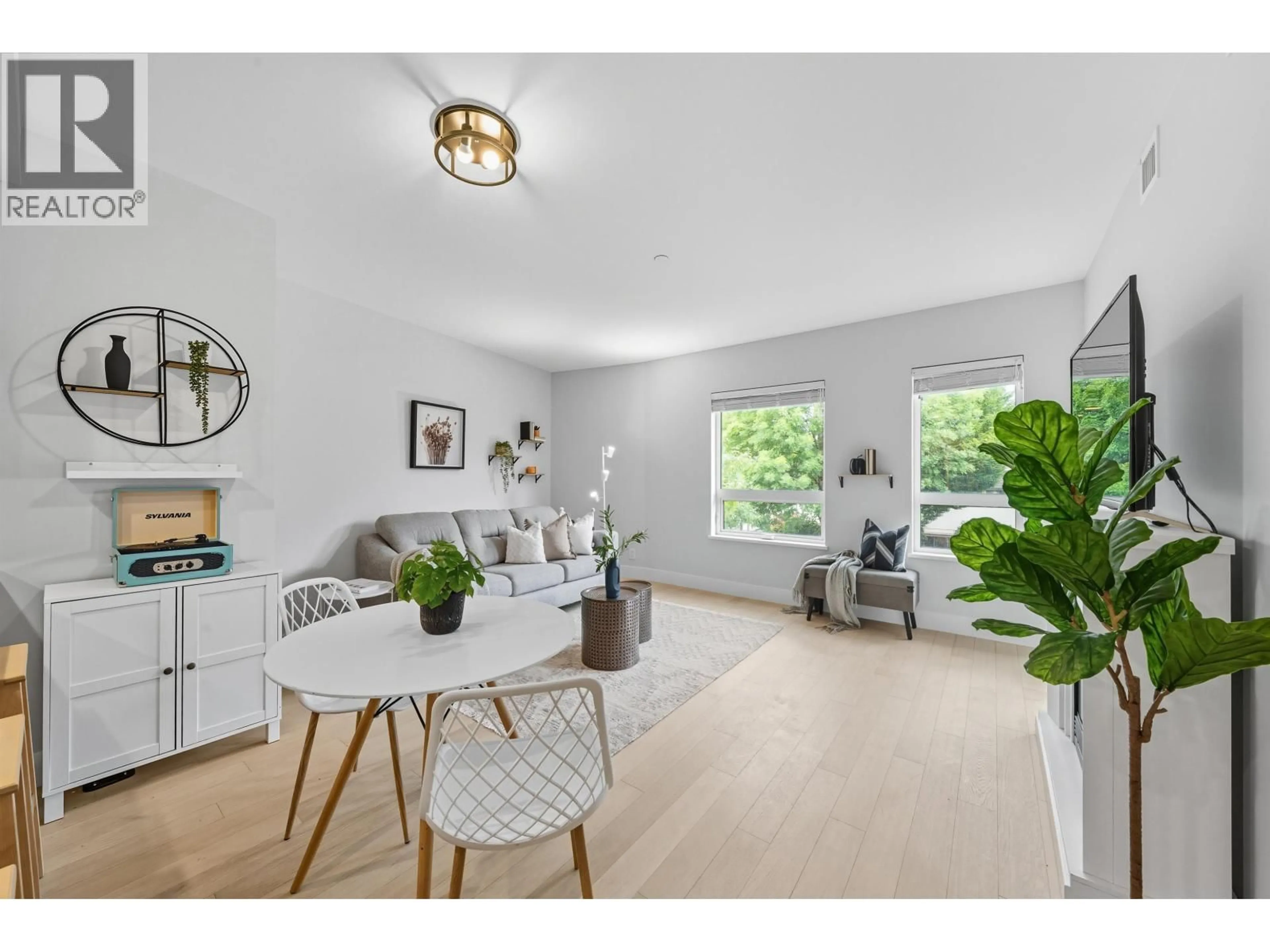 Living room with furniture, wood/laminate floor for 201 - 22226 BROWN AVENUE, Maple Ridge British Columbia V2X4R2