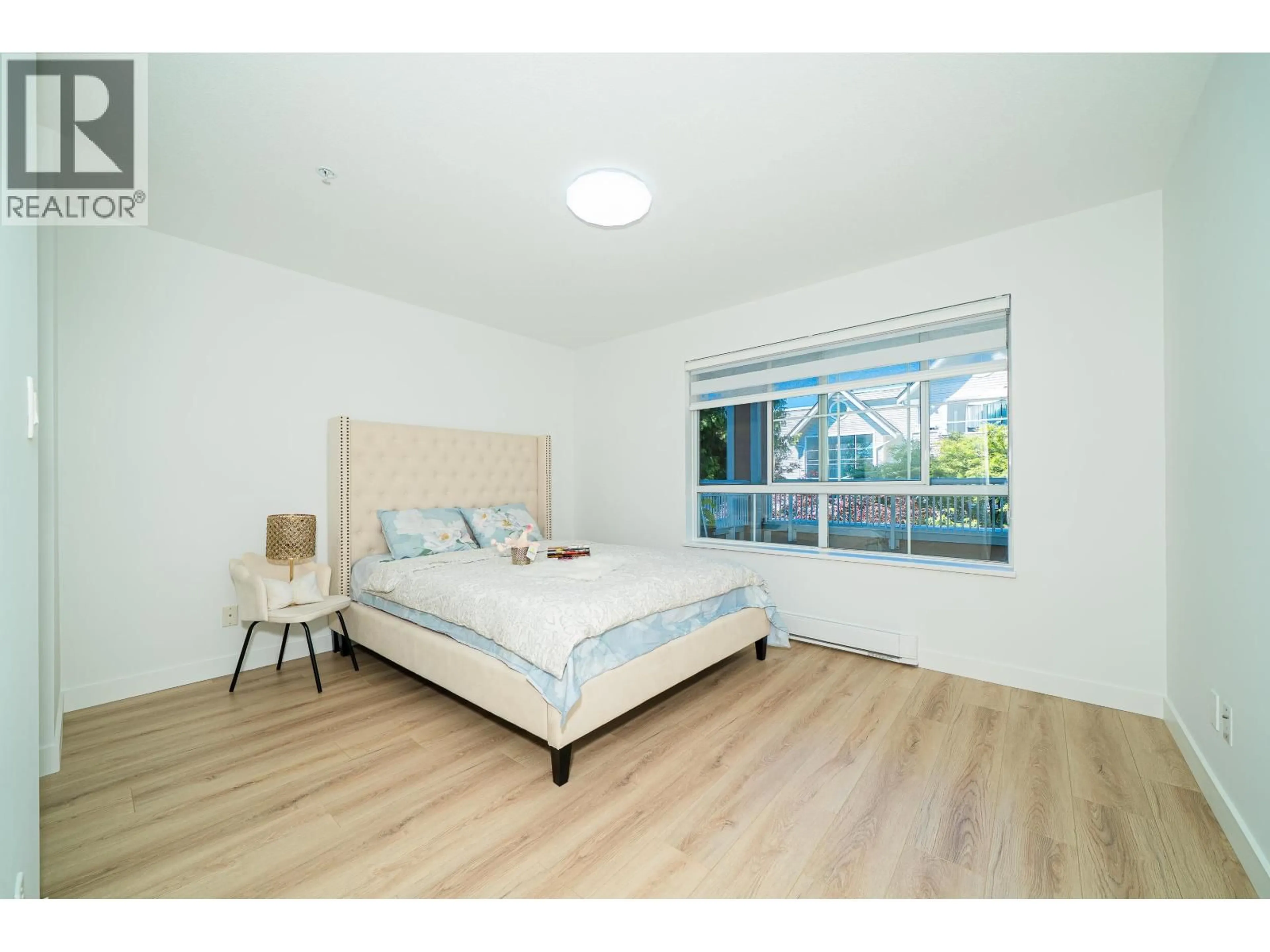Bedroom with bed, wood/laminate floor for 211 - 7117 ANTRIM AVENUE, Burnaby British Columbia V5J5K1