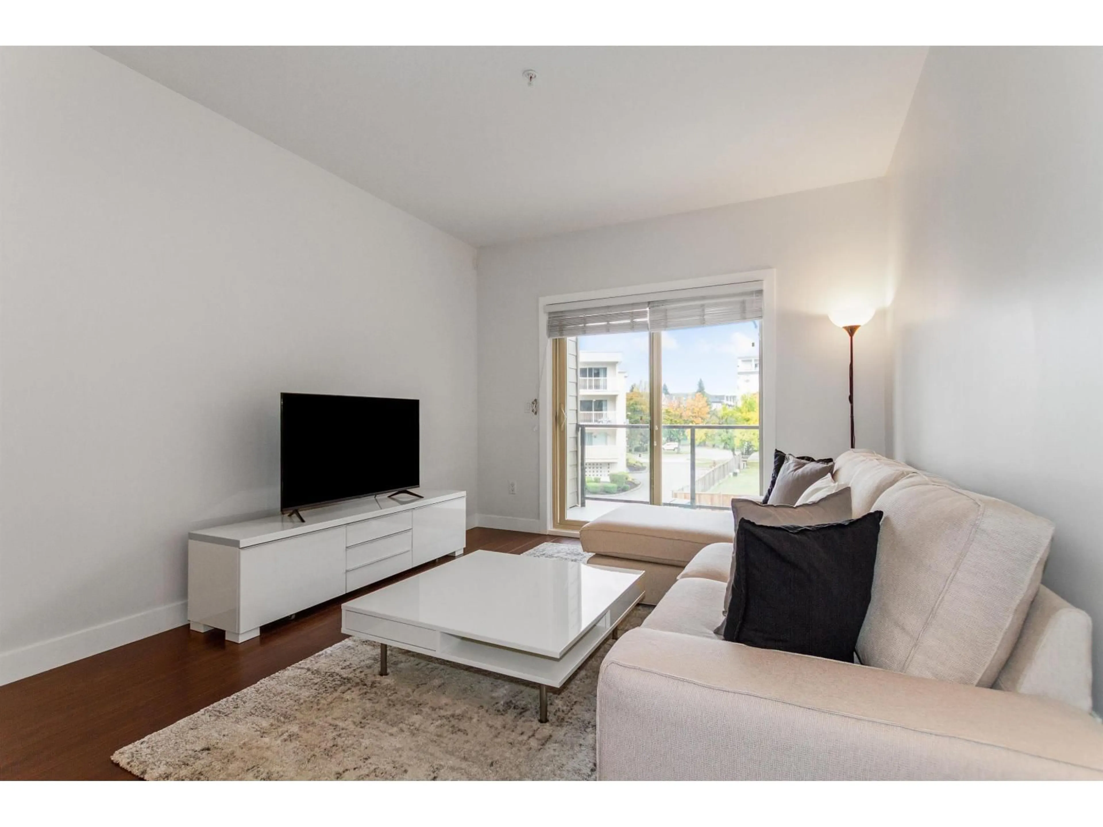 Living room with furniture, wood/laminate floor for 210 - 20219 54A, Langley British Columbia V3A0C7