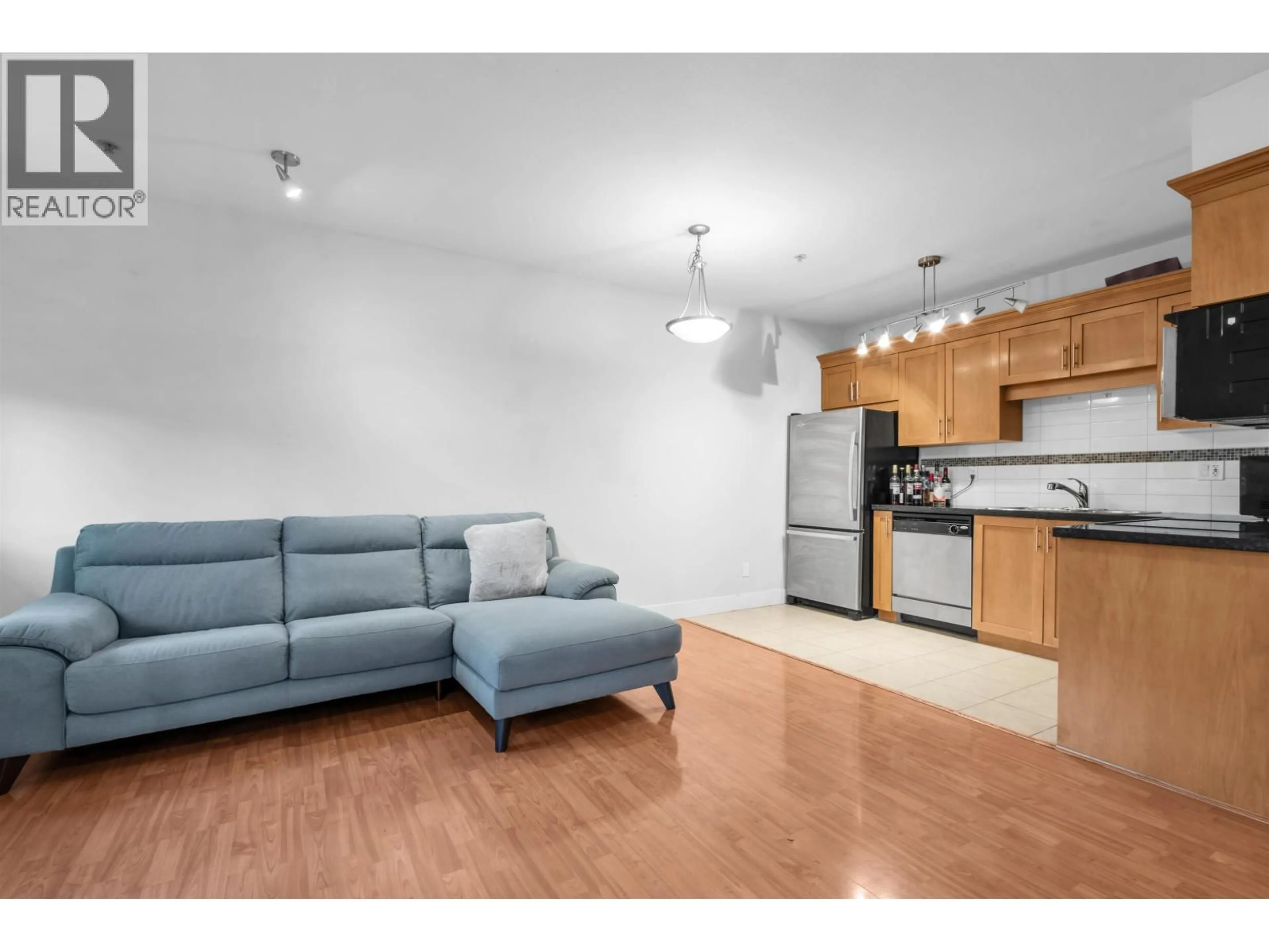 Living room with furniture, wood/laminate floor for 1 - 8400 COOK ROAD, Richmond British Columbia V6Y1V5