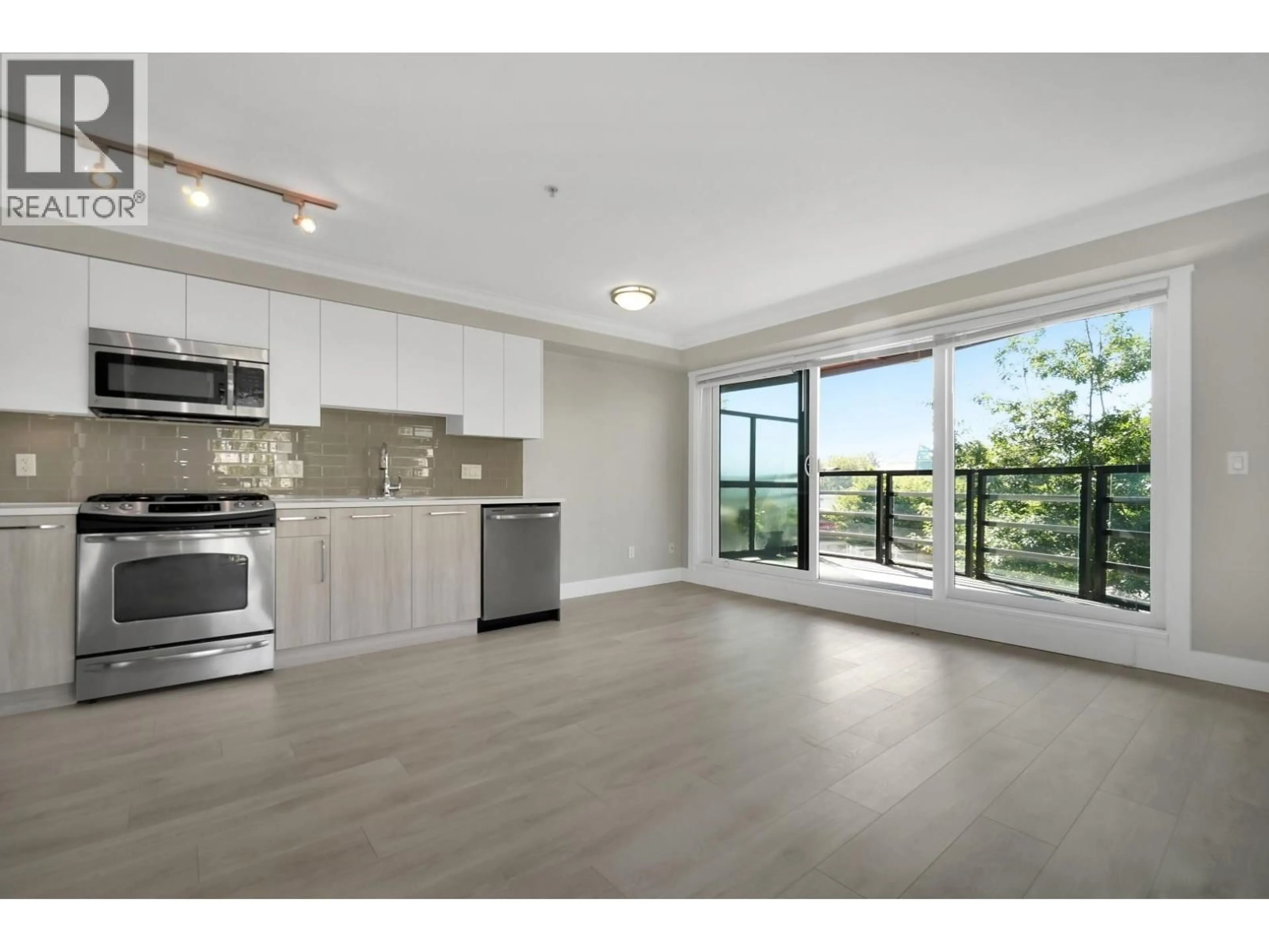 Open concept kitchen, wood/laminate floor for 309 - 857 15TH STREET, North Vancouver British Columbia V7P1M5