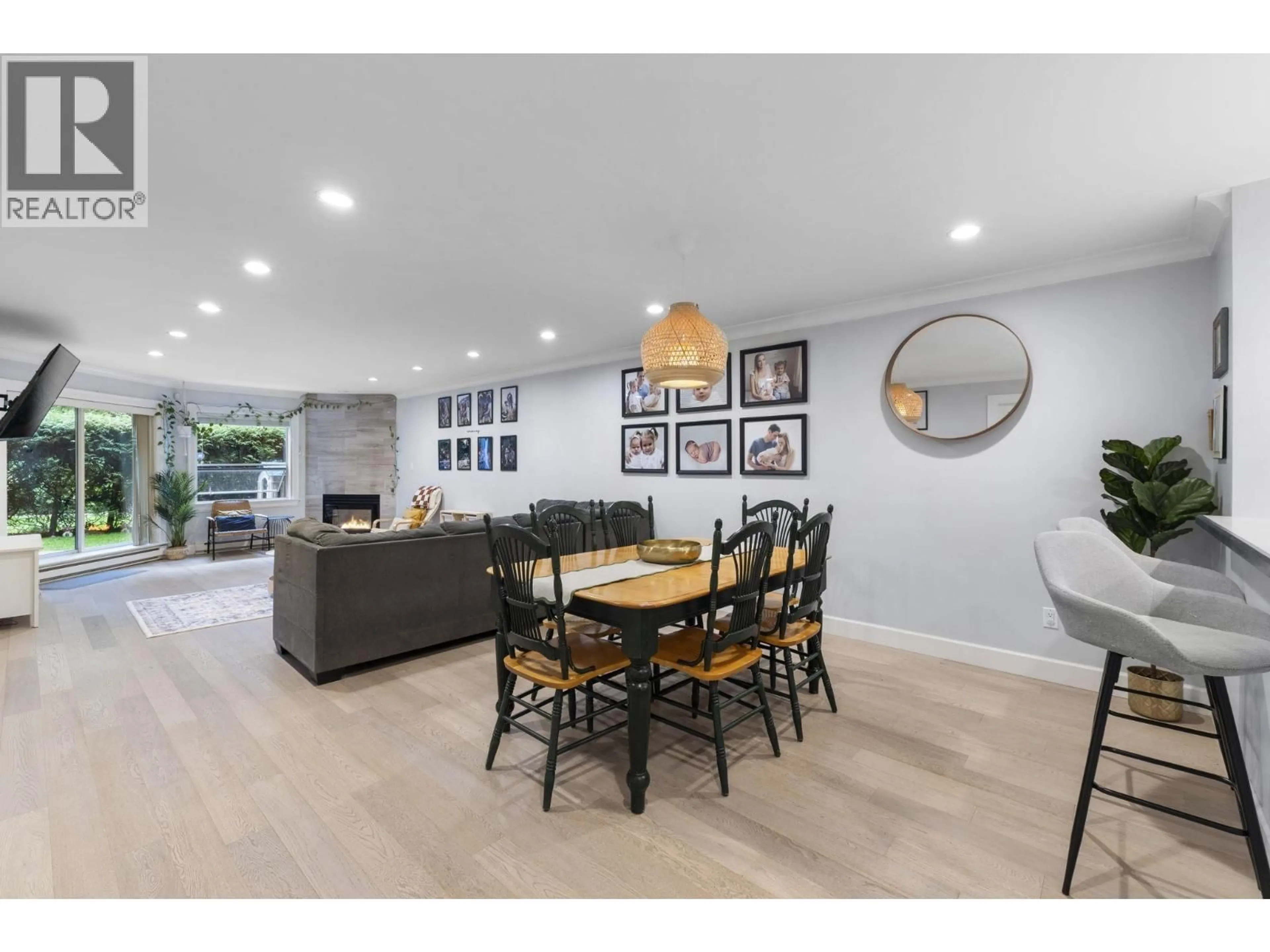 Open concept kitchen, wood/laminate floor for 102 - 1500 OSTLER COURT, North Vancouver British Columbia V7G2S2