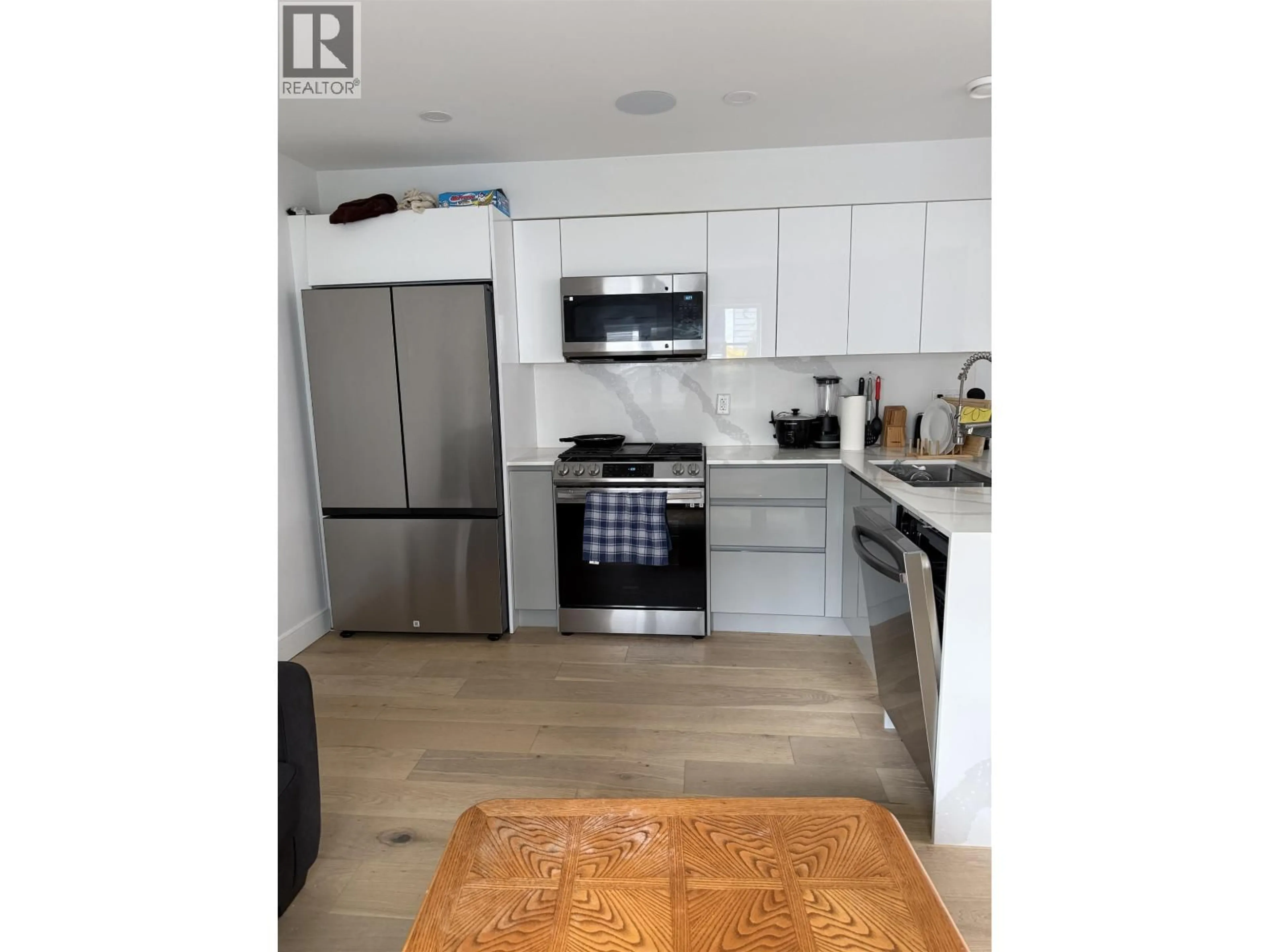 Open concept kitchen, wood/laminate floor for 2885 GEORGIA STREET, Vancouver British Columbia V5K2K3