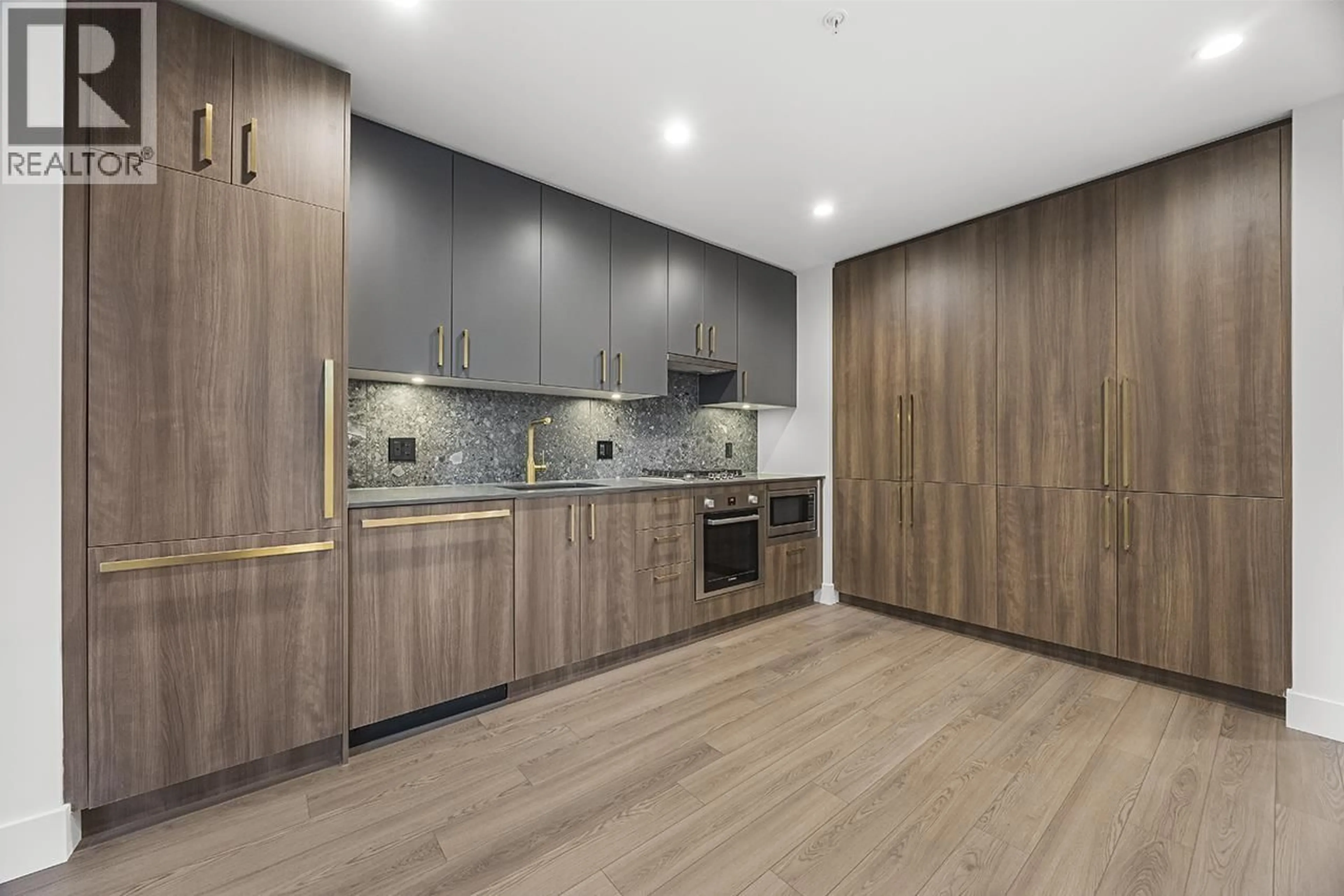 Open concept kitchen, wood/laminate floor for 104 - 2375 EMERY COURT, Vancouver British Columbia V7J0E8