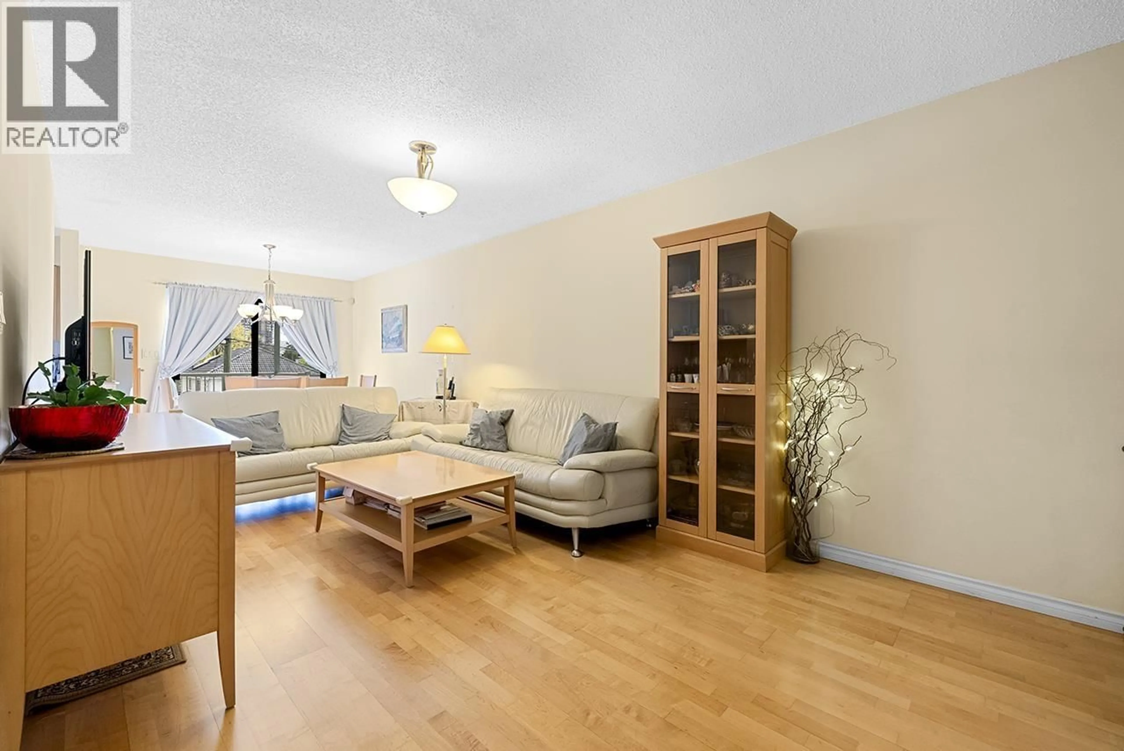 Living room with furniture, wood/laminate floor for 8416 - 8420 SHAUGHNESSY STREET, Vancouver British Columbia V6P3Y2