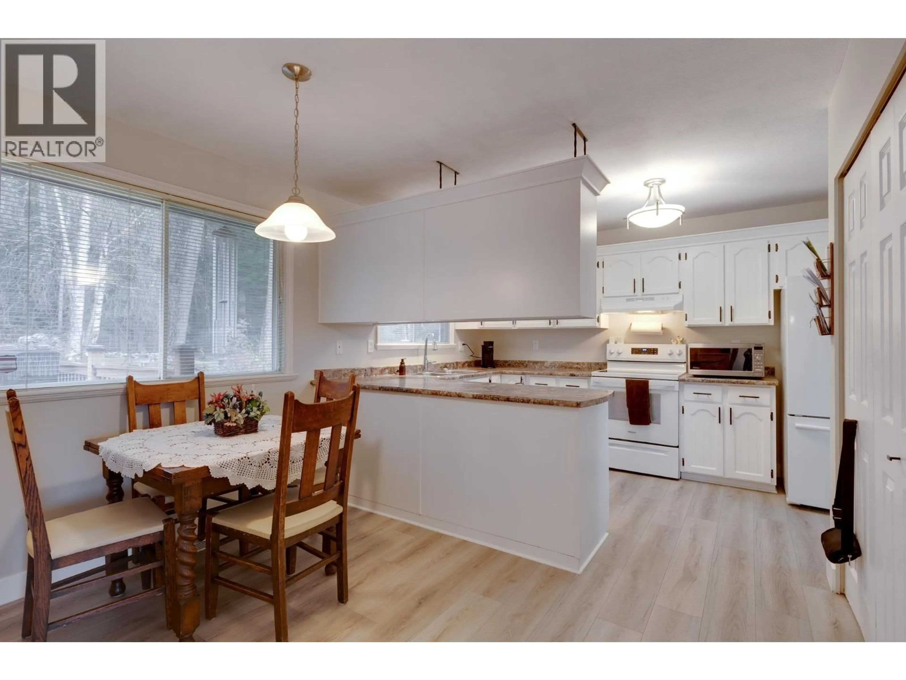 Open concept kitchen, wood/laminate floor for 4882 NORTH MEADOW ROAD, Prince George British Columbia V2K4E6