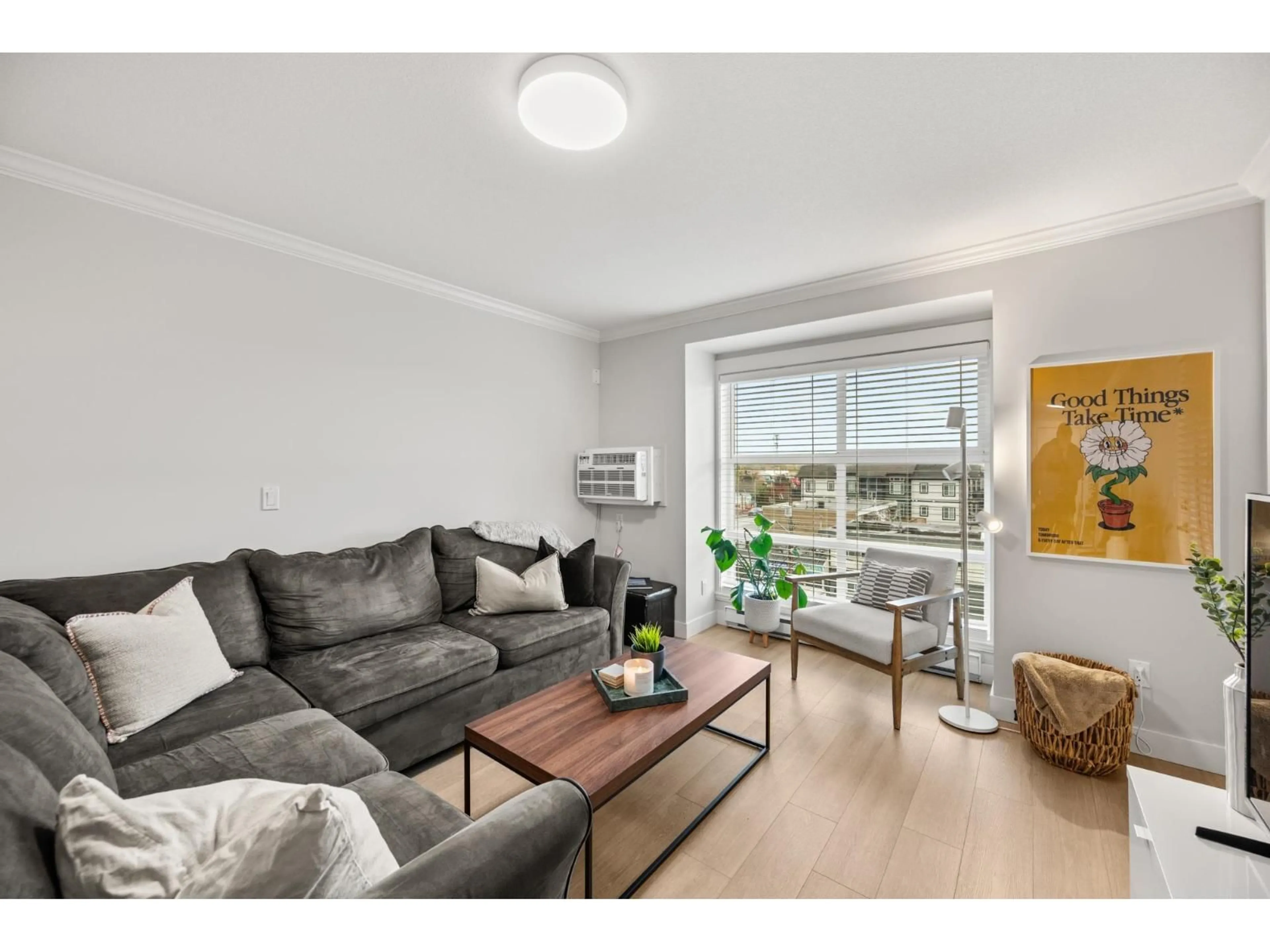 Living room with furniture, wood/laminate floor for 423 - 17769 57, Surrey British Columbia V3S1H1