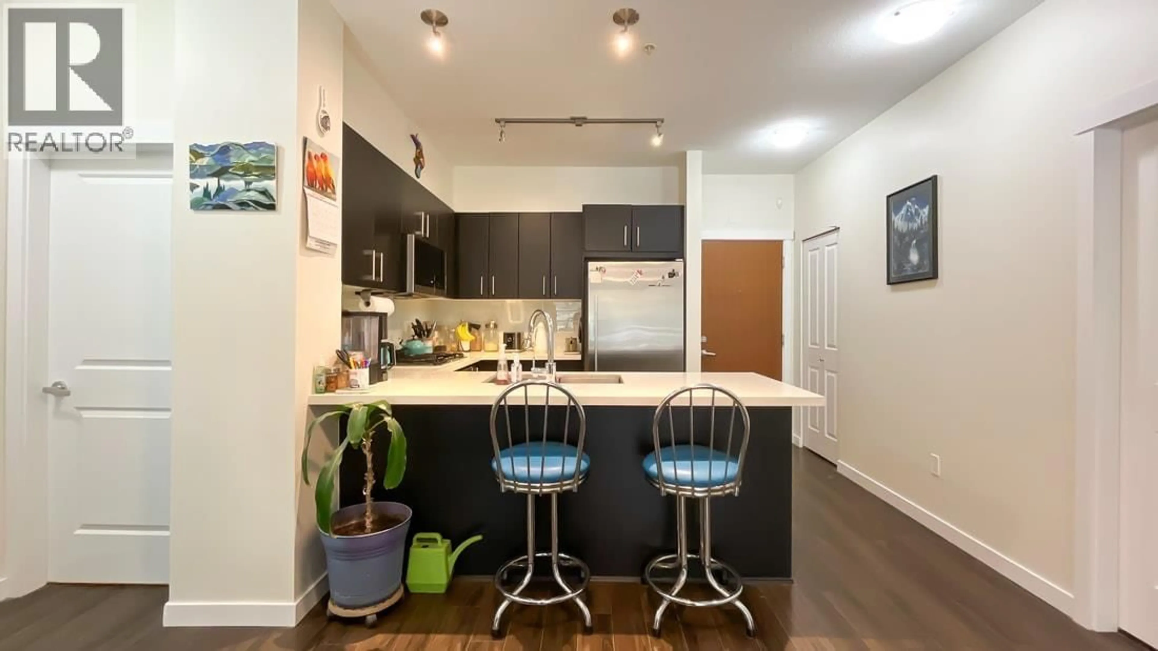 Open concept kitchen, wood/laminate floor for 111 - 3163 RIVERWALK AVENUE, Vancouver British Columbia V5S0A8