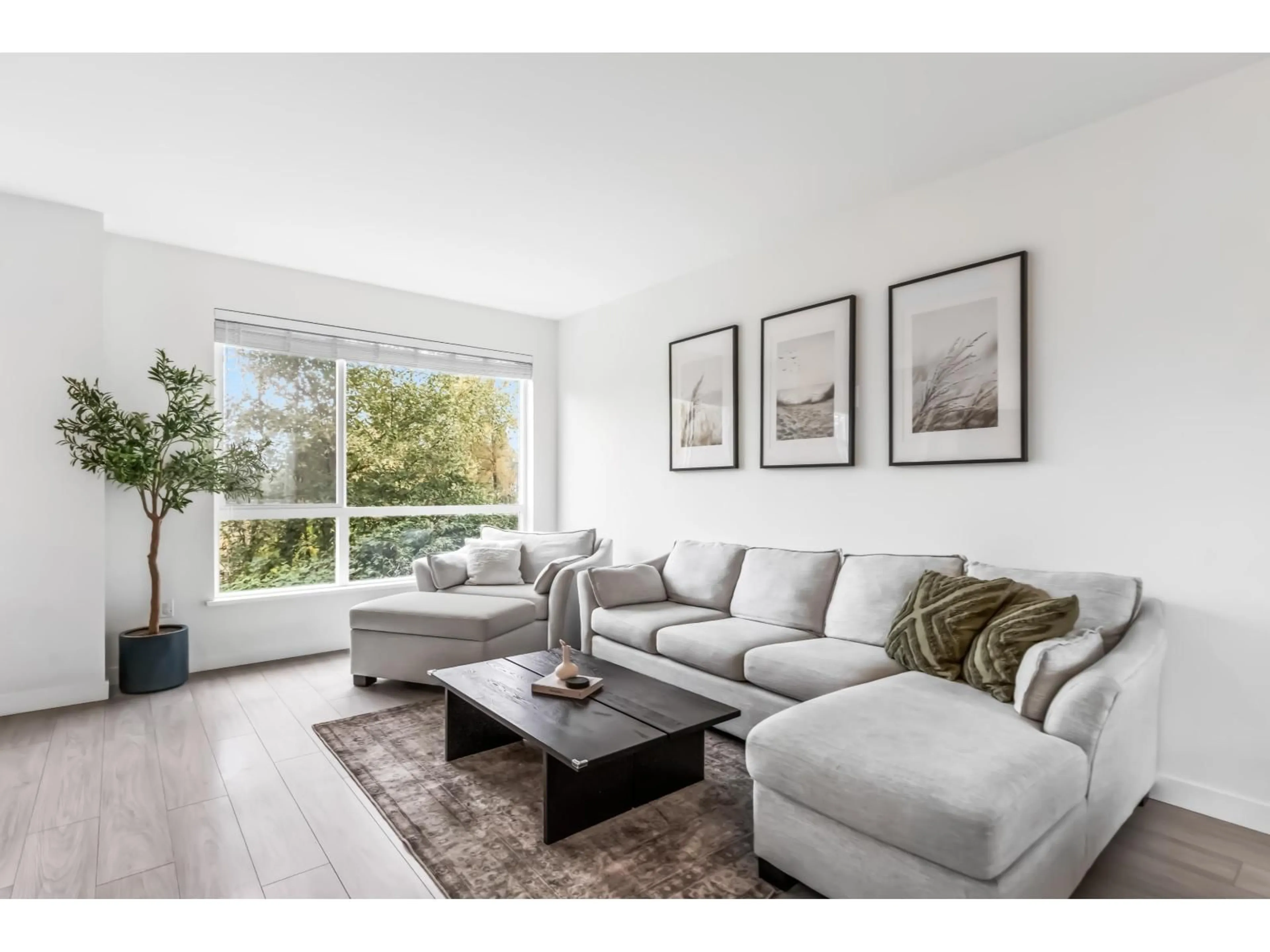 Living room with furniture, wood/laminate floor for 10 - 7288 188, Surrey British Columbia V4N6W3