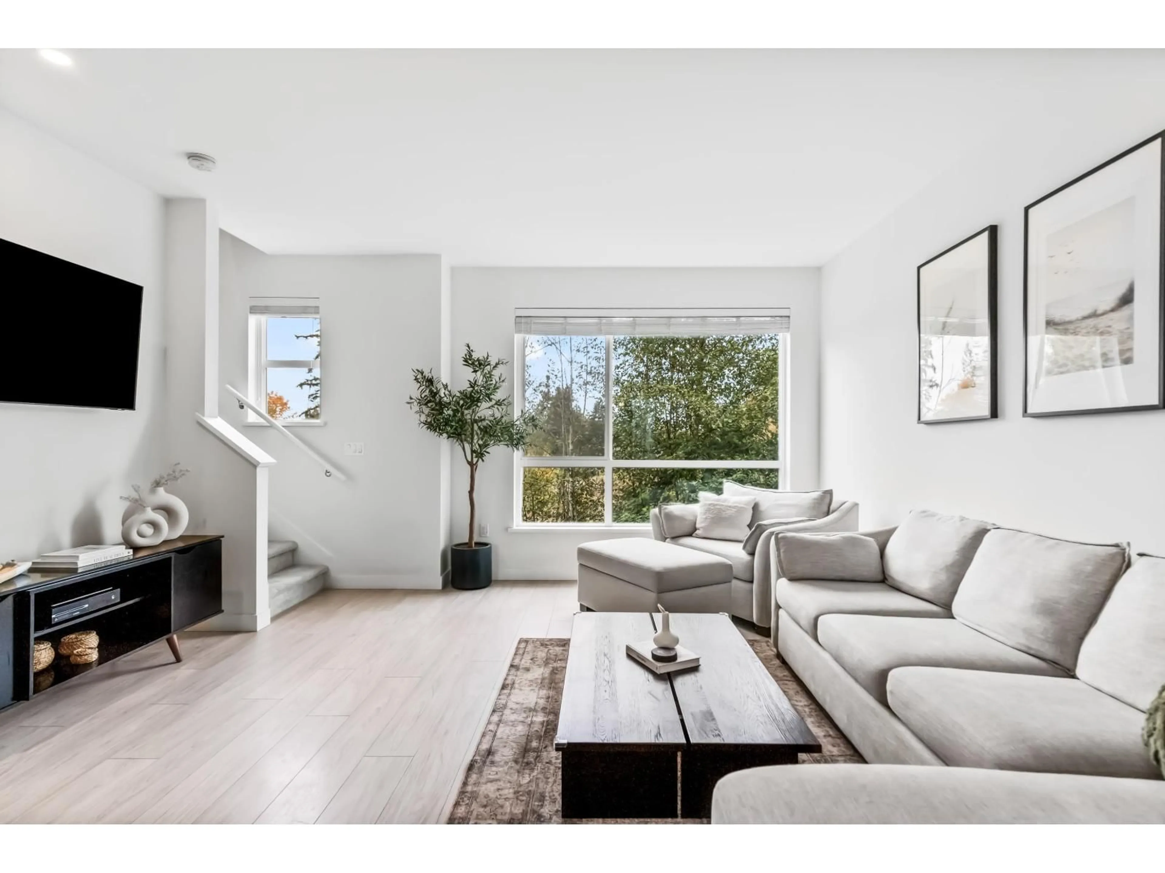 Living room with furniture, wood/laminate floor for 10 - 7288 188, Surrey British Columbia V4N6W3