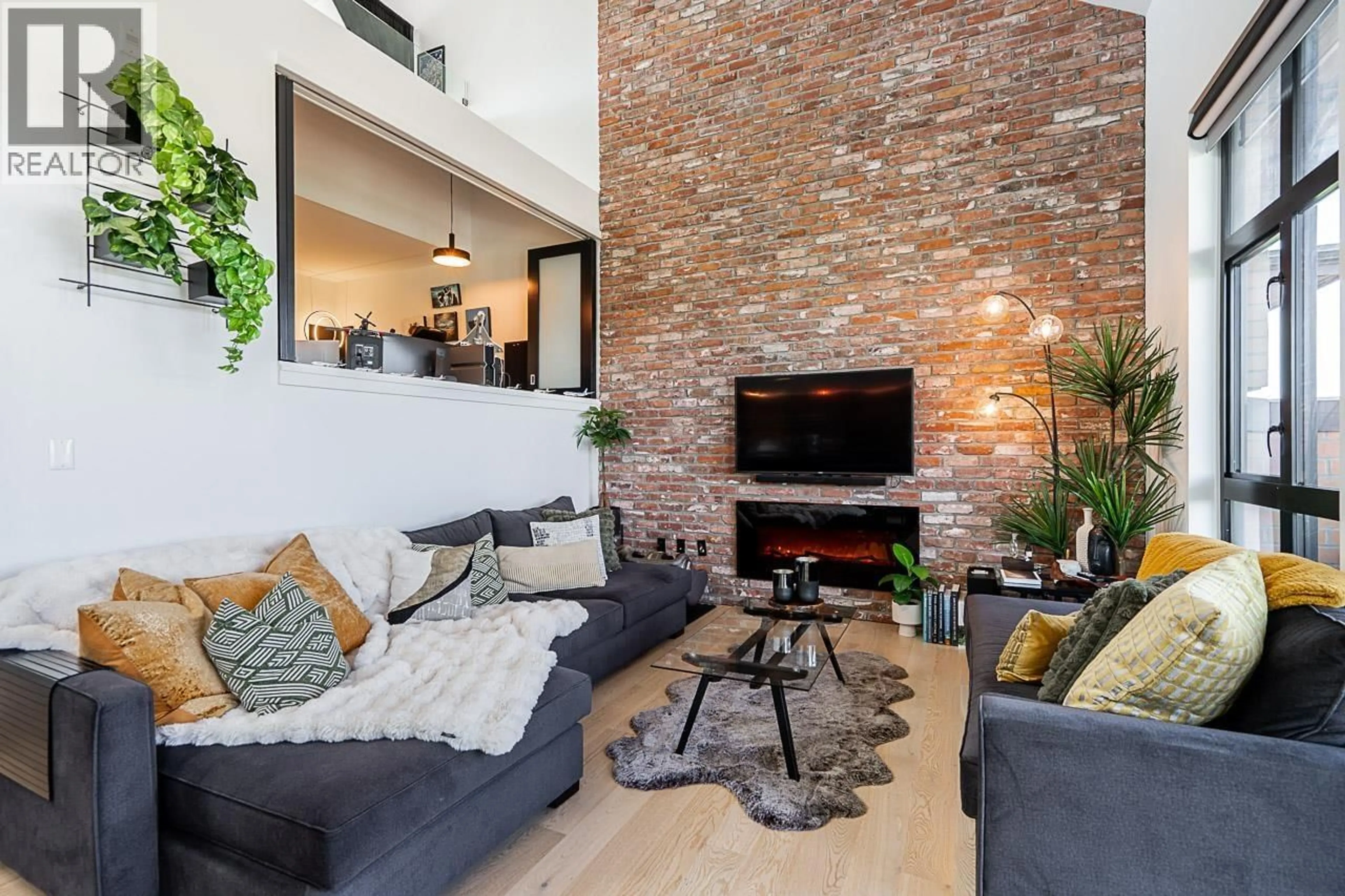 Living room with furniture, cement floor for 416 - 220 SALTER STREET, New Westminster British Columbia V3M0H4