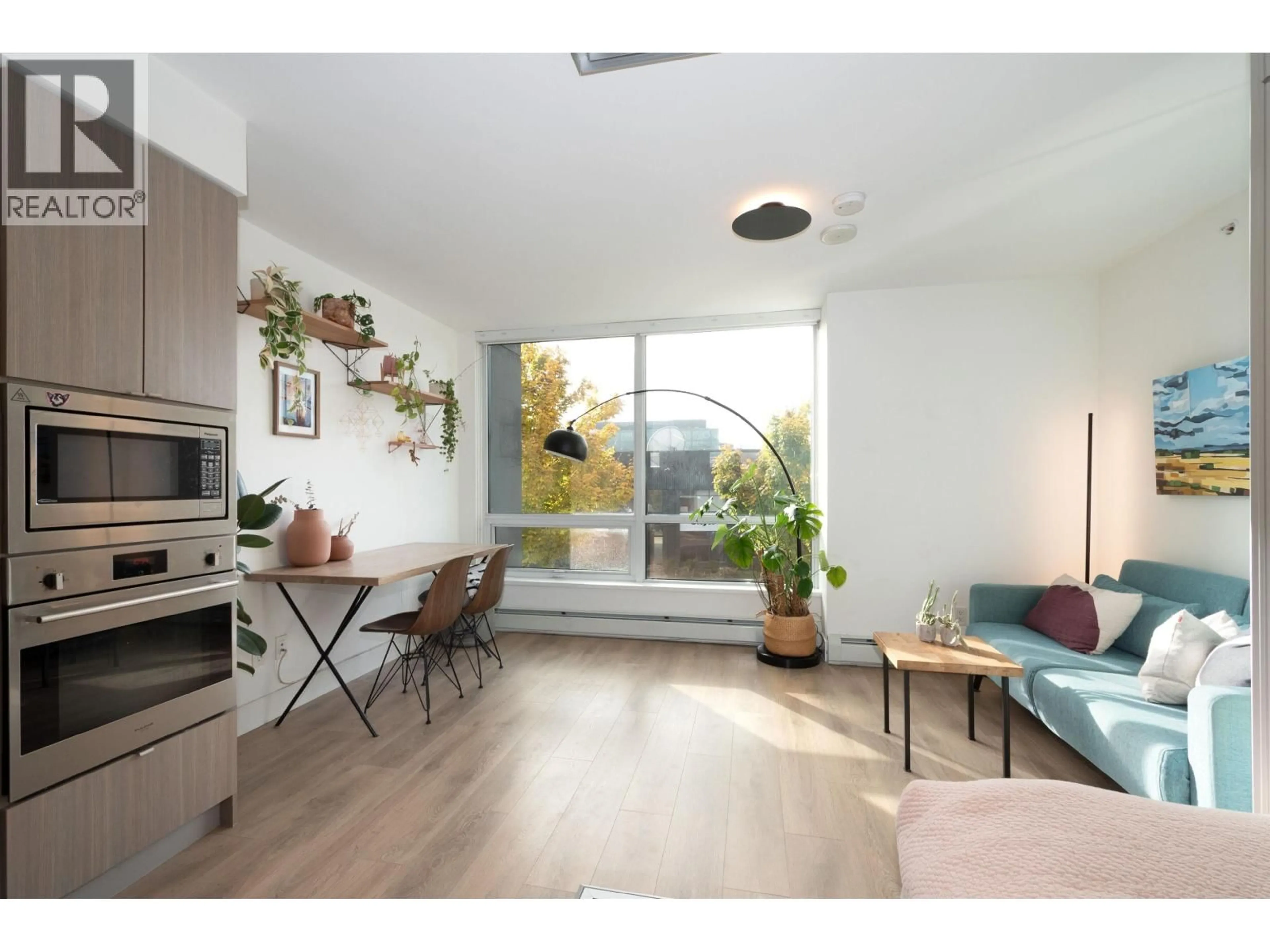 Living room with furniture, wood/laminate floor for 208 - 1788 COLUMBIA STREET, Vancouver British Columbia V5Y0L7