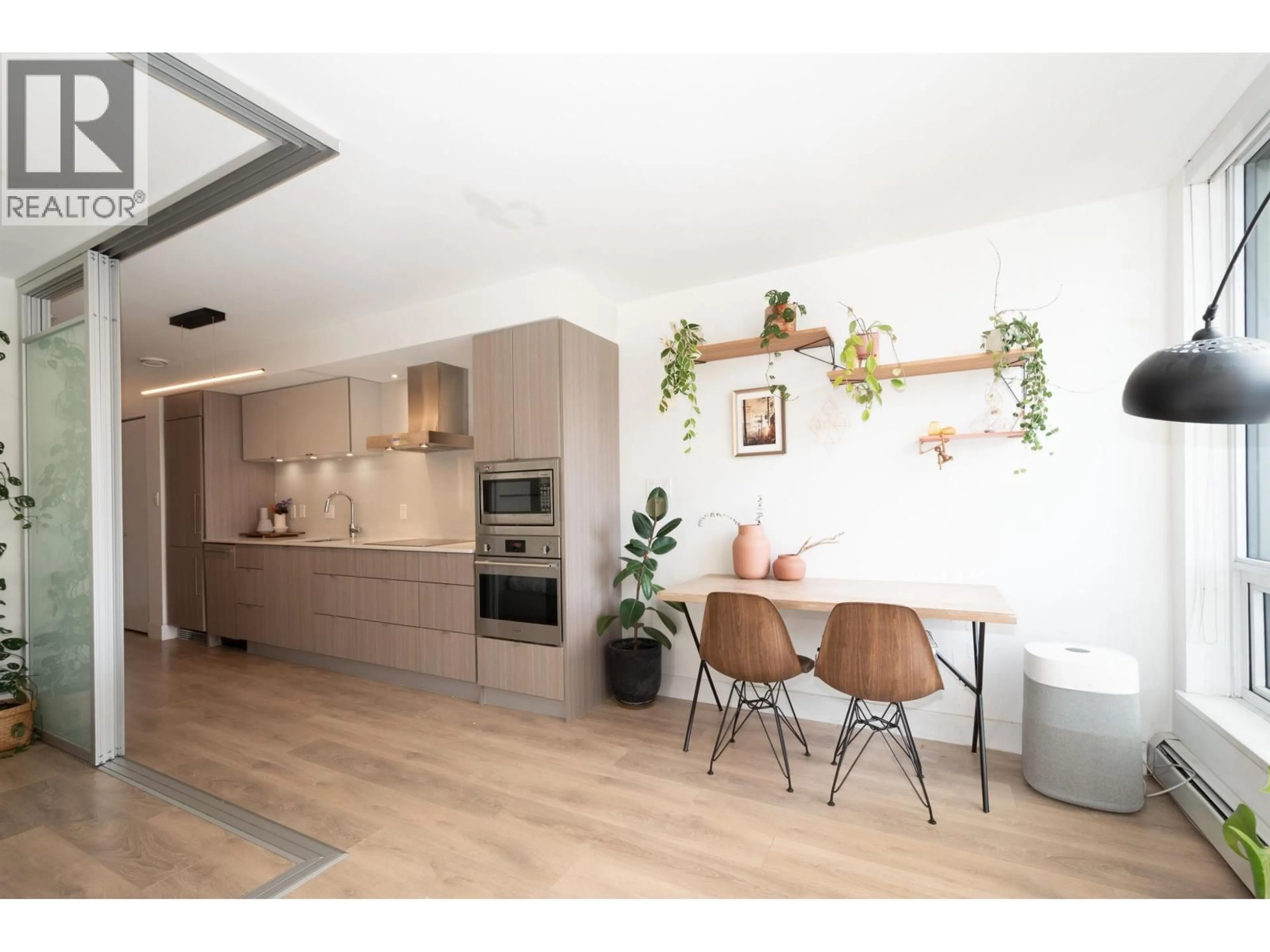 Open concept kitchen, wood/laminate floor for 208 - 1788 COLUMBIA STREET, Vancouver British Columbia V5Y0L7