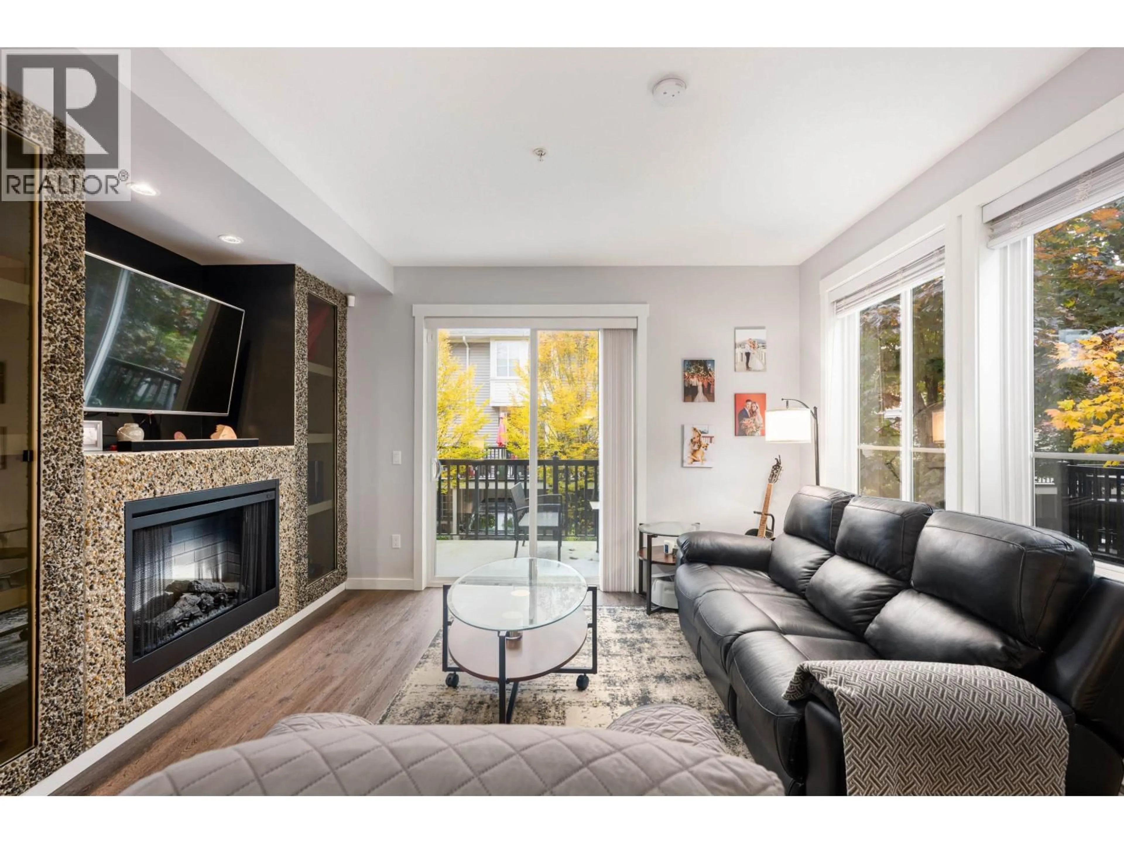 Living room with furniture, wood/laminate floor for 129 - 2418 AVON PLACE, Port Coquitlam British Columbia V3B0C7