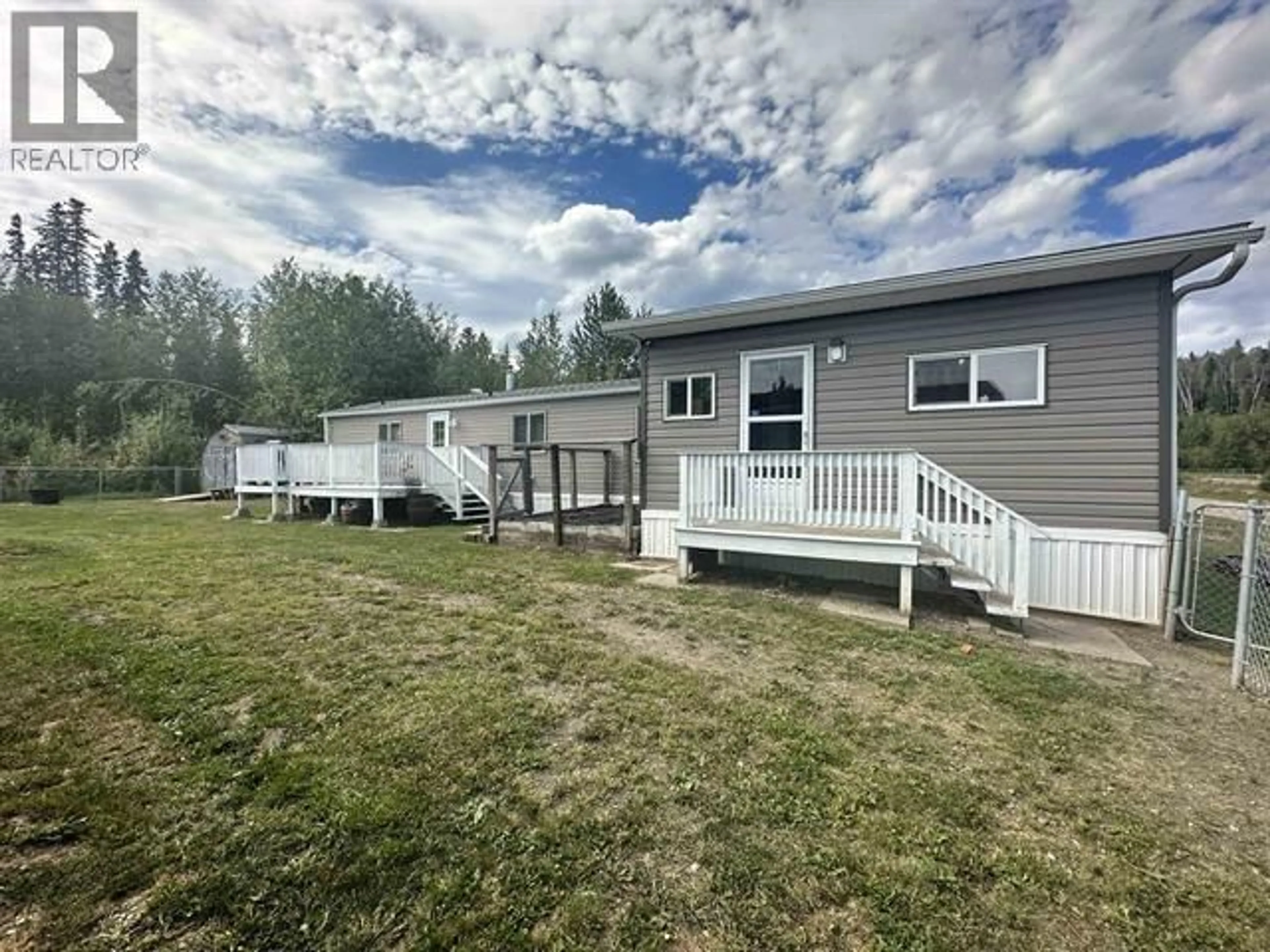 A pic from outside/outdoor area/front of a property/back of a property/a pic from drone, water/lake/river/ocean view for 16 - 5701 AIRPORT DRIVE, Fort Nelson British Columbia V0C1R0