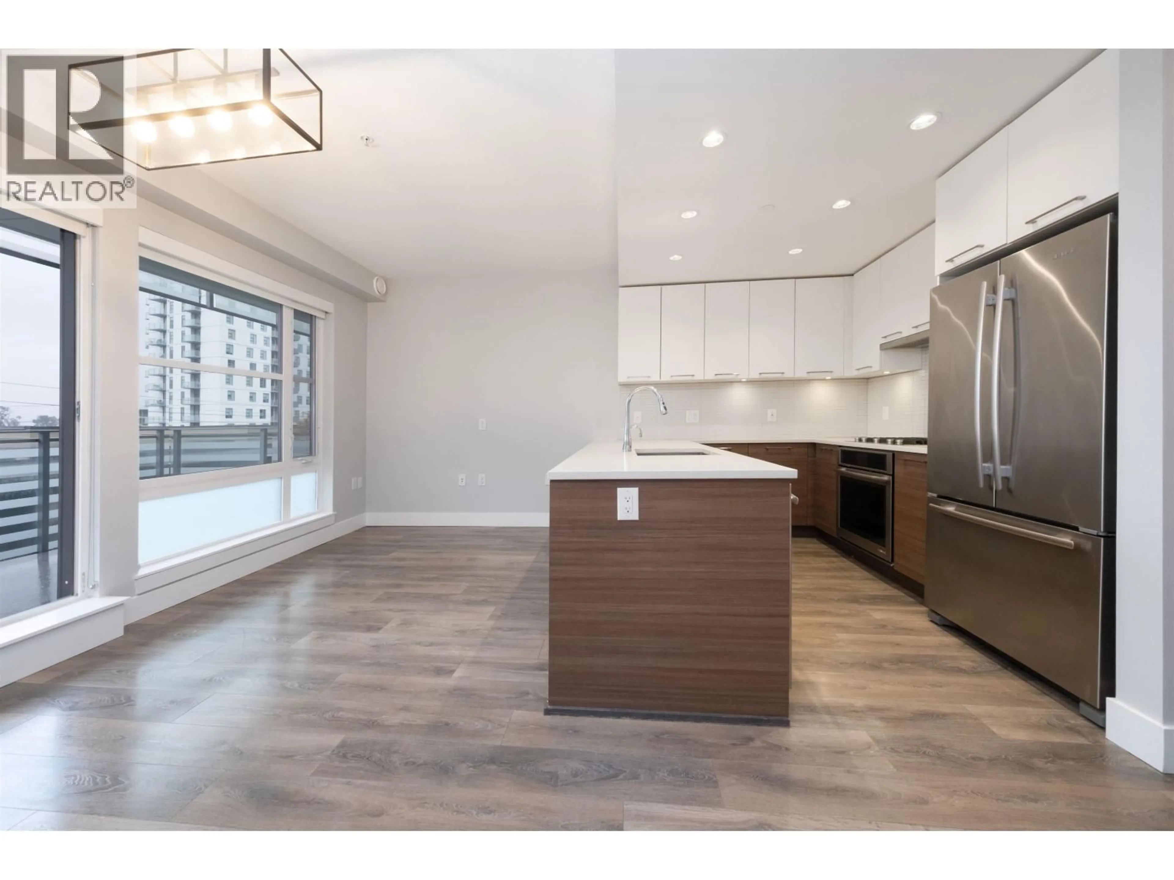 Open concept kitchen, wood/laminate floor for 501 - 3488 SAWMILL CRESCENT, Vancouver British Columbia V5S0C7