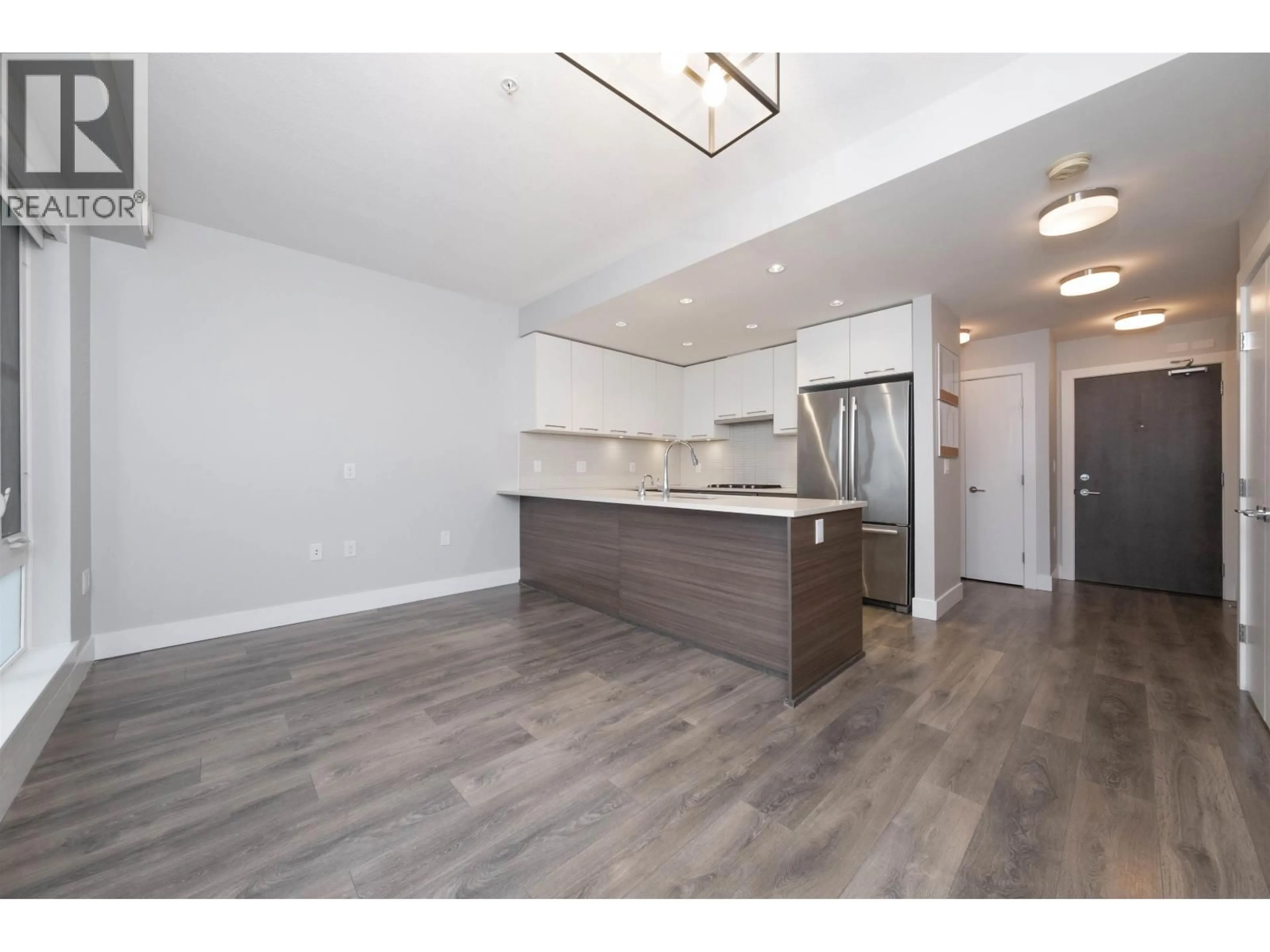 Open concept kitchen, wood/laminate floor for 501 - 3488 SAWMILL CRESCENT, Vancouver British Columbia V5S0C7
